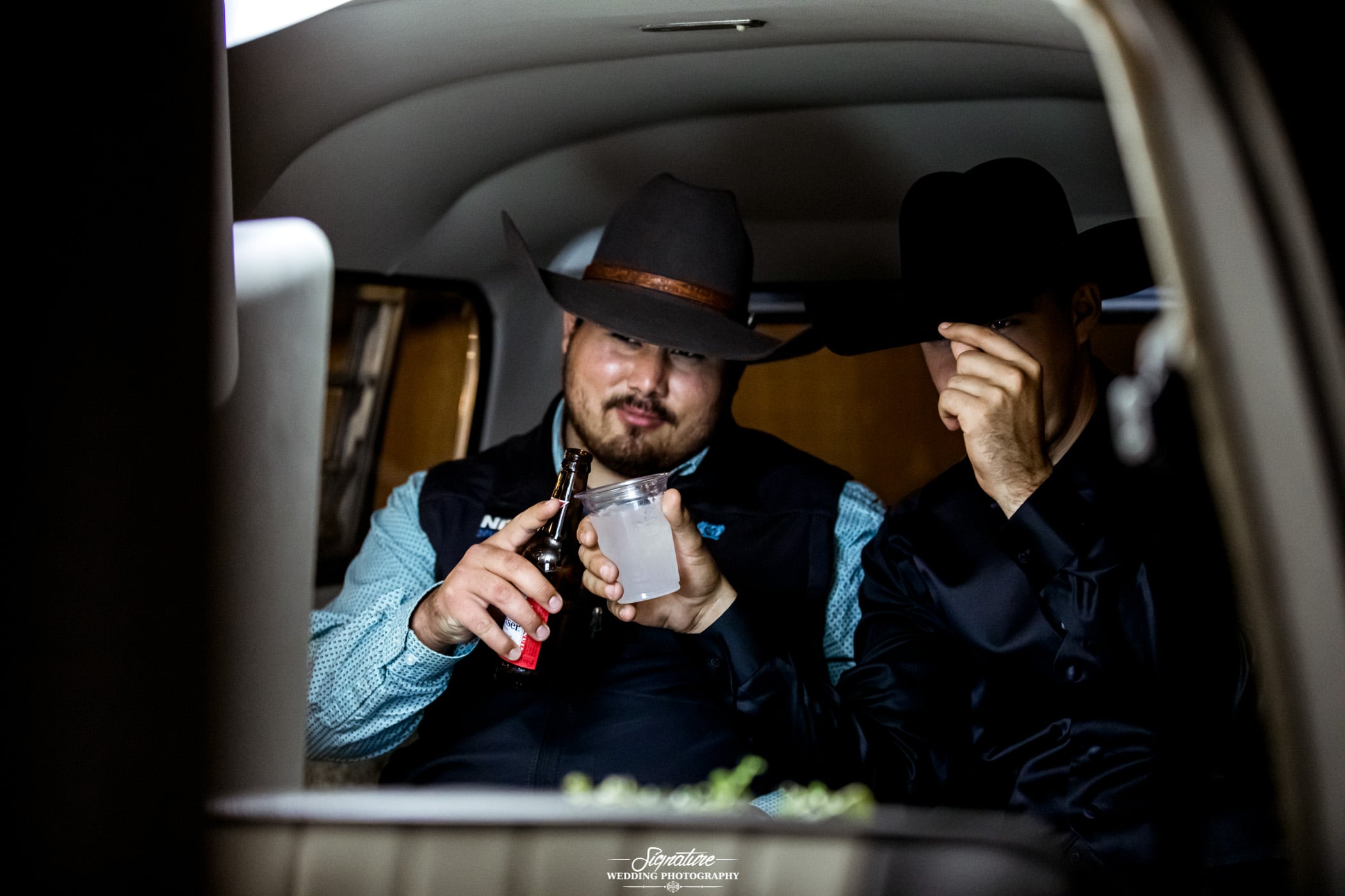 Men in cowboy hats toasting drinks