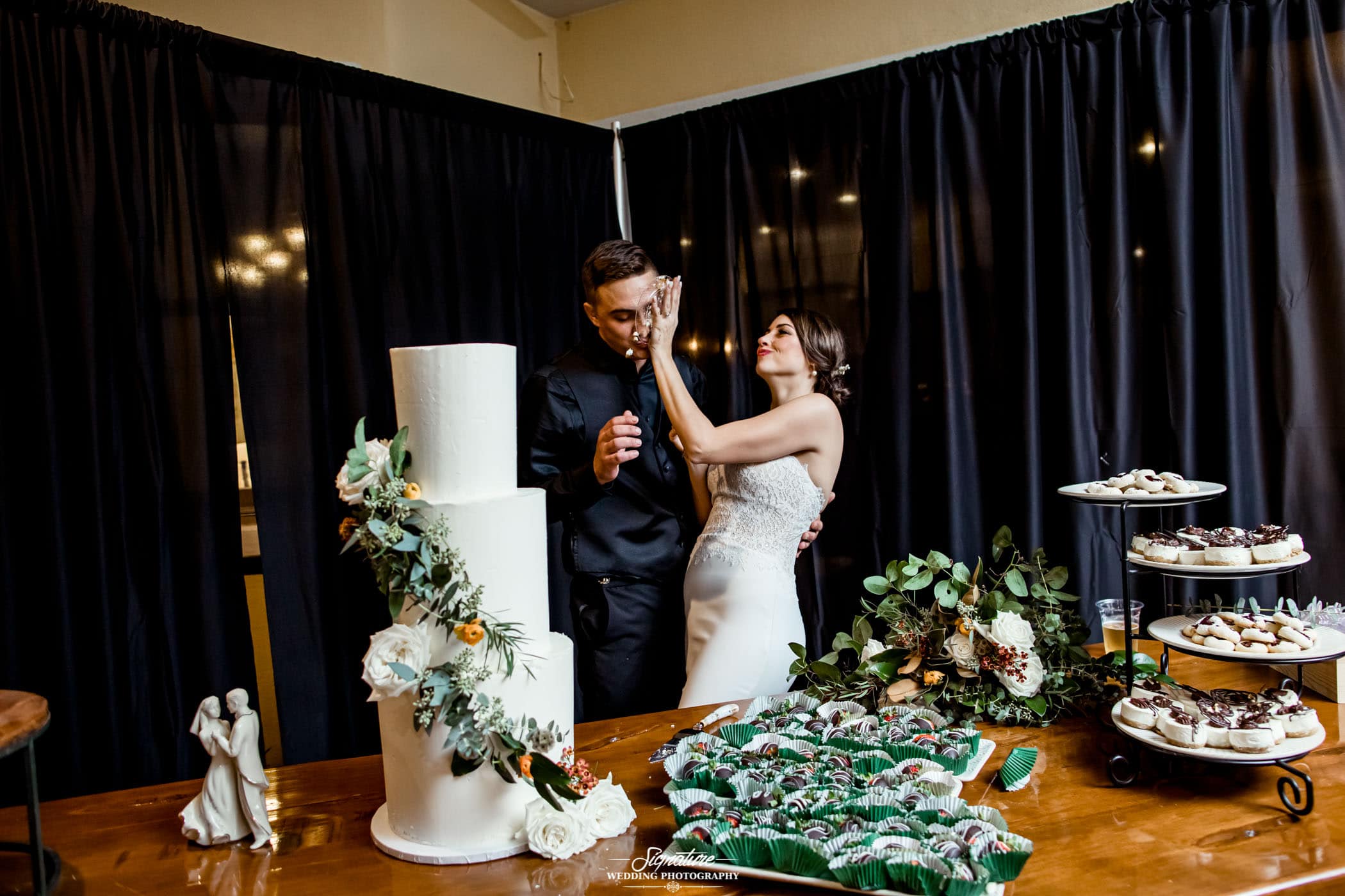 Bride putting cake in groom's face