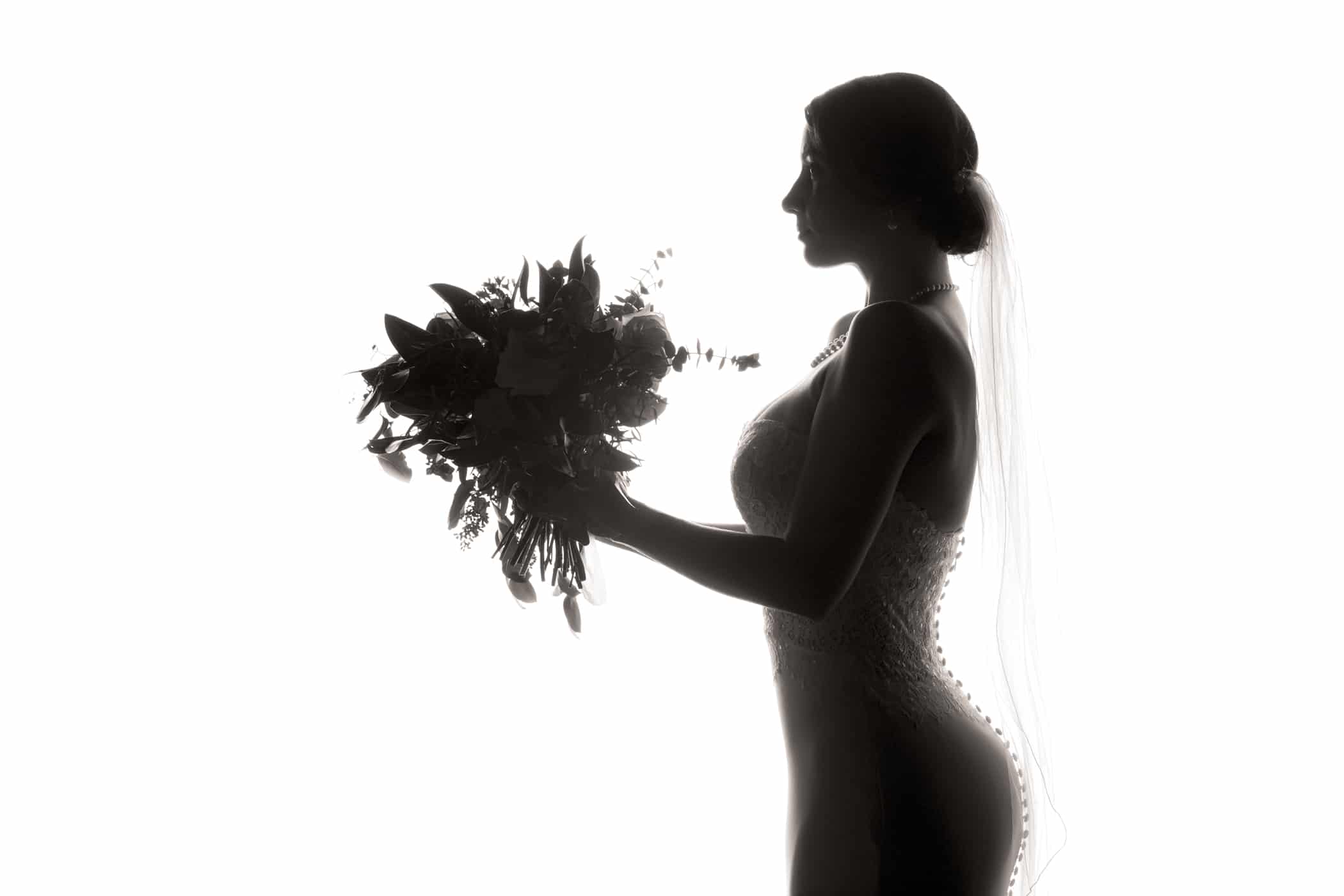 Bride holding bouquet silhouette