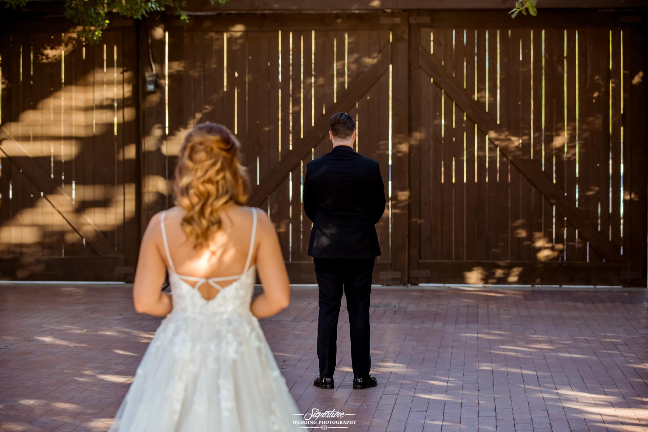 Bride behind groom facing away for first look