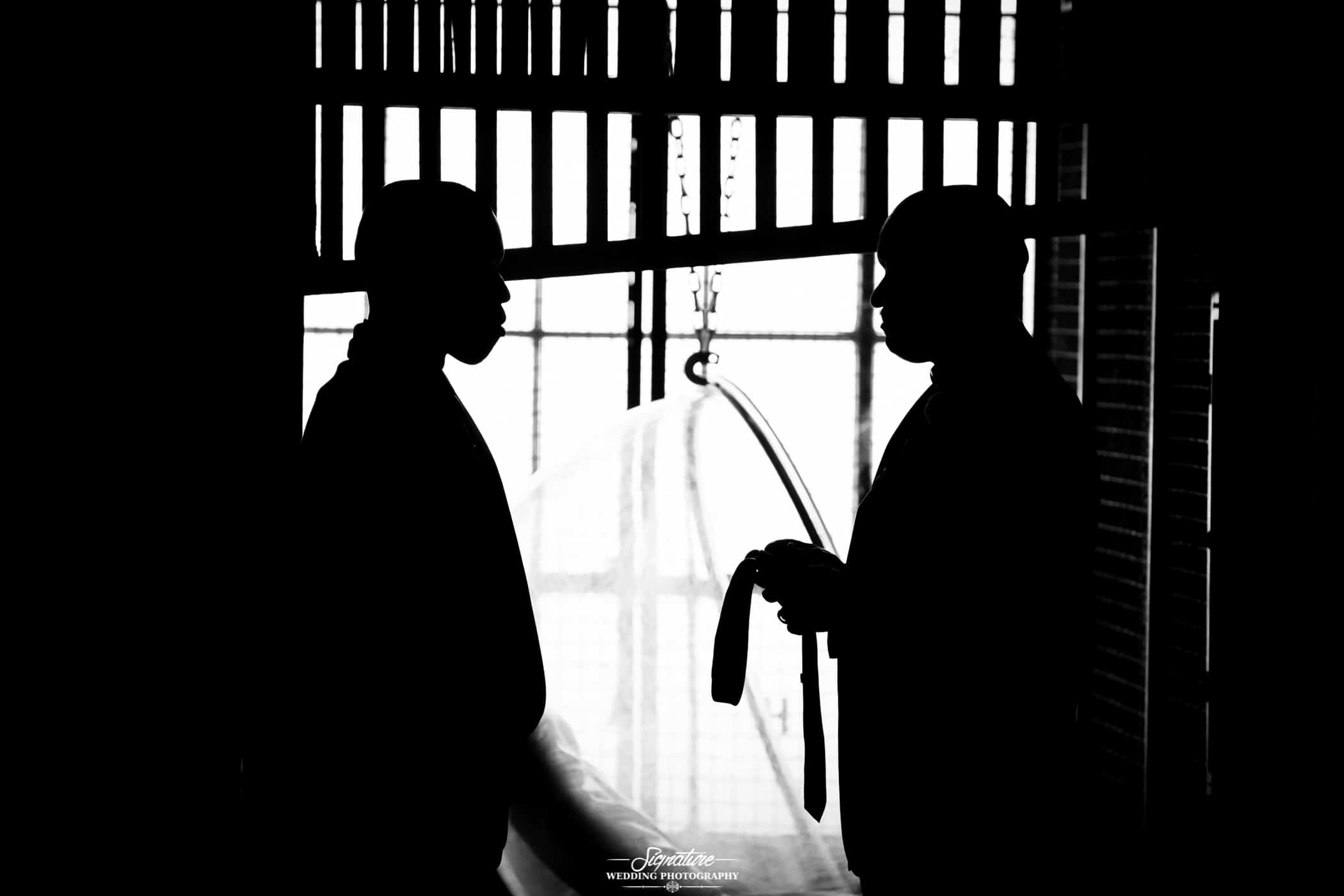 Groom and father holding tie silhouette
