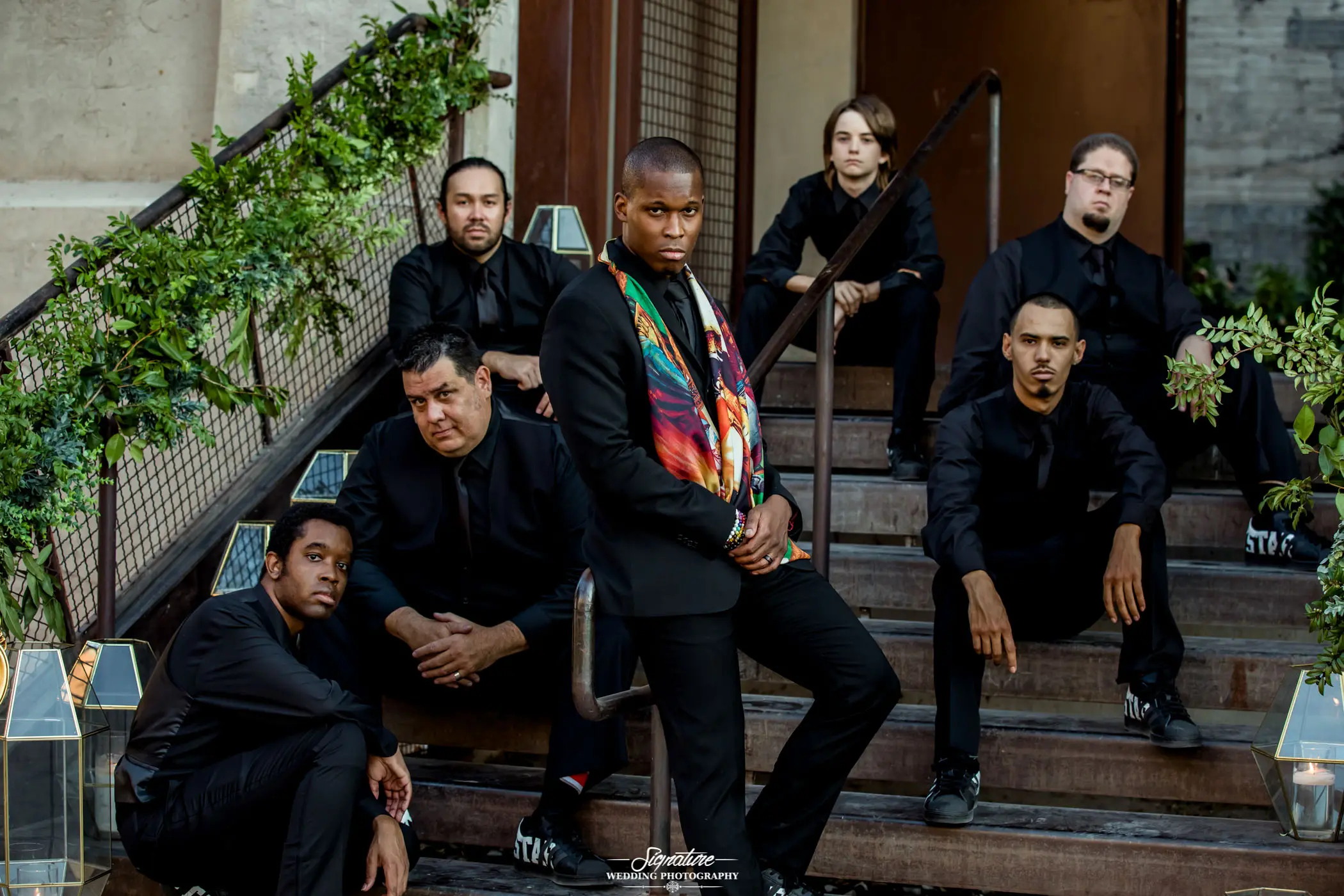 Groom with groomsmen sitting on stairs