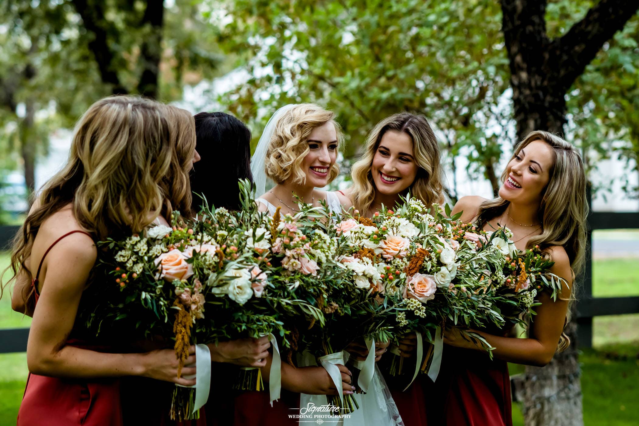 Bride with bridesmaids smiling at each other