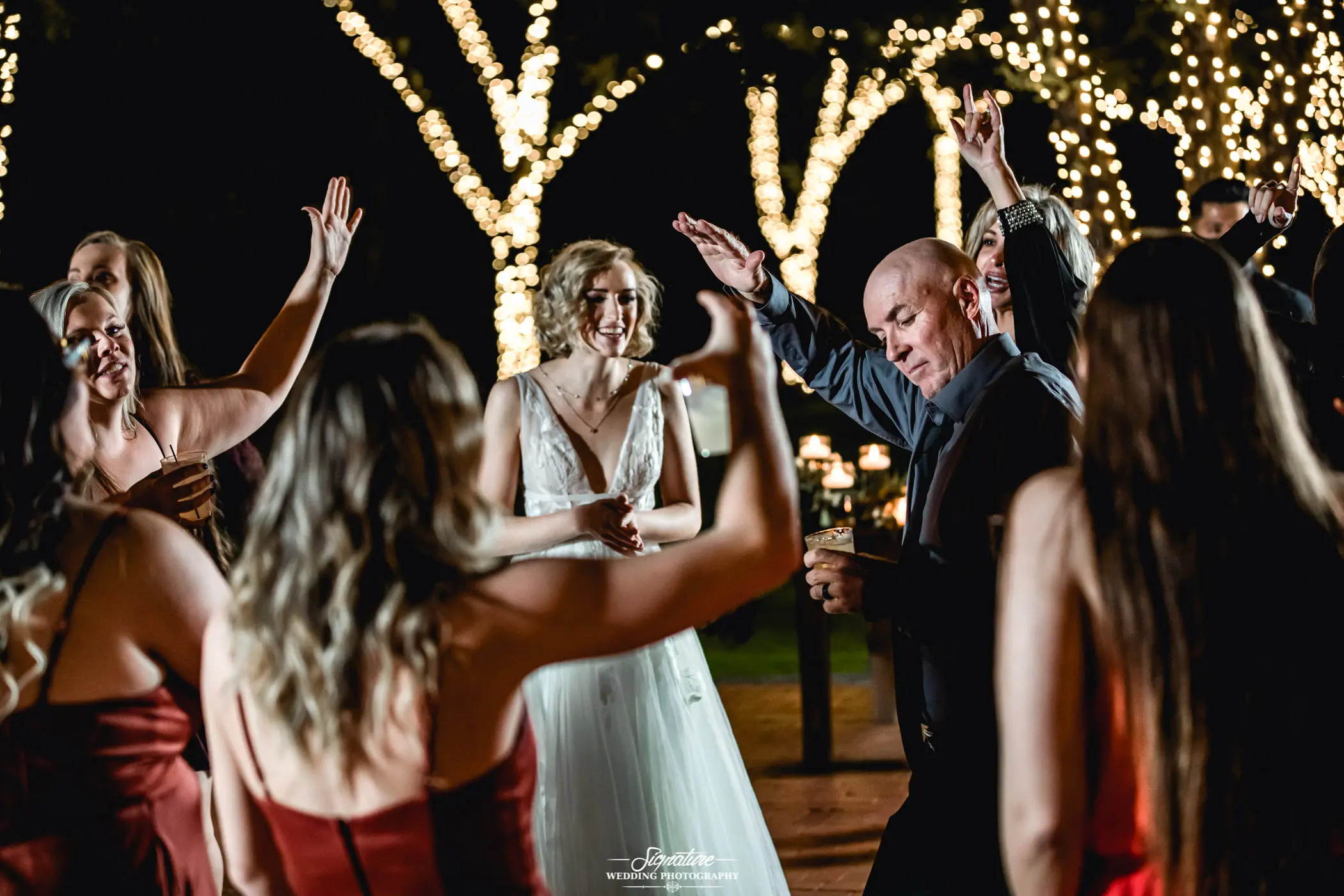 Bride and wedding guests dancing at reception