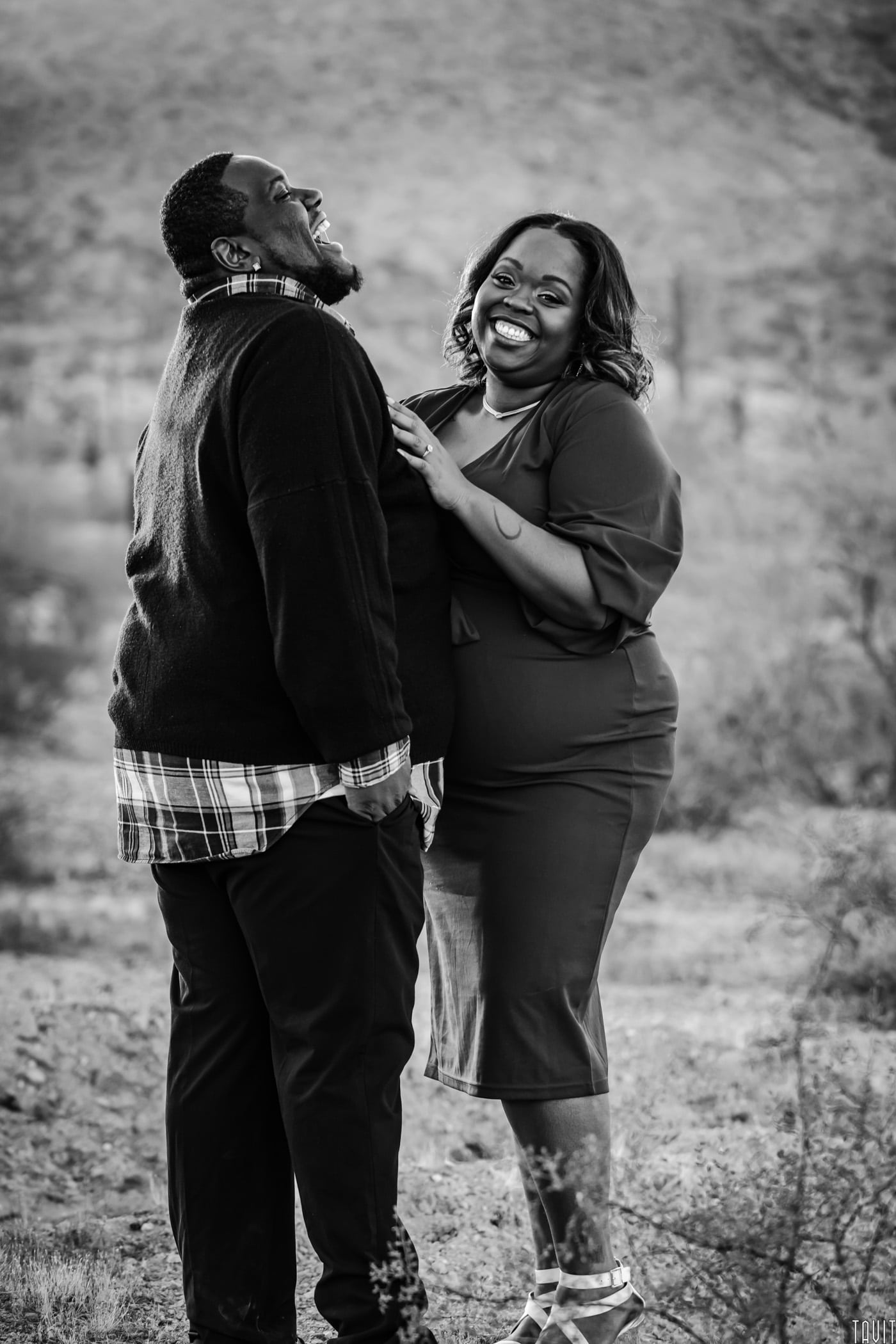 Couple smiling and laughing in desert black and white