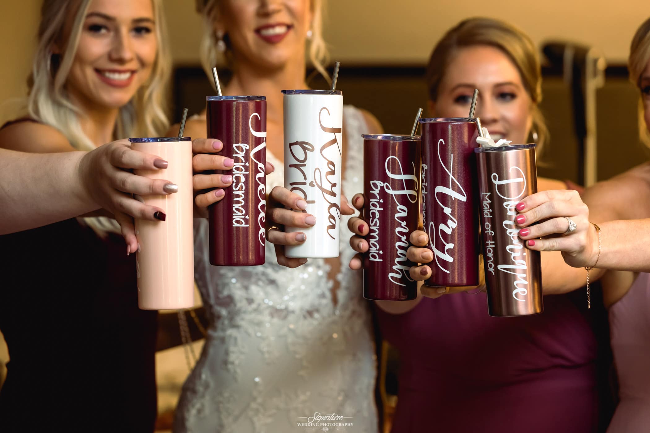 Bridal party raising a toast with custom wedding cups