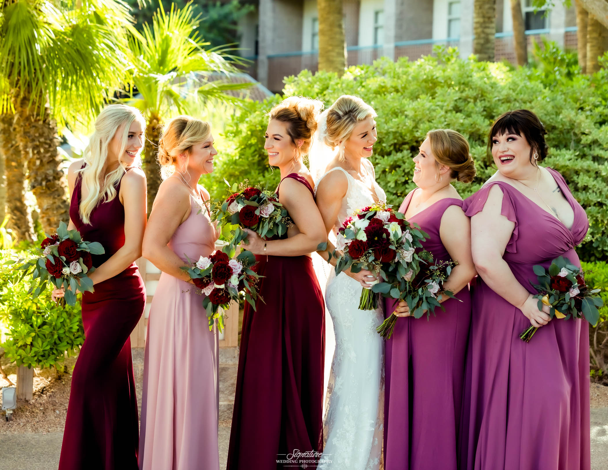 Bride with bridal party smiling at each other