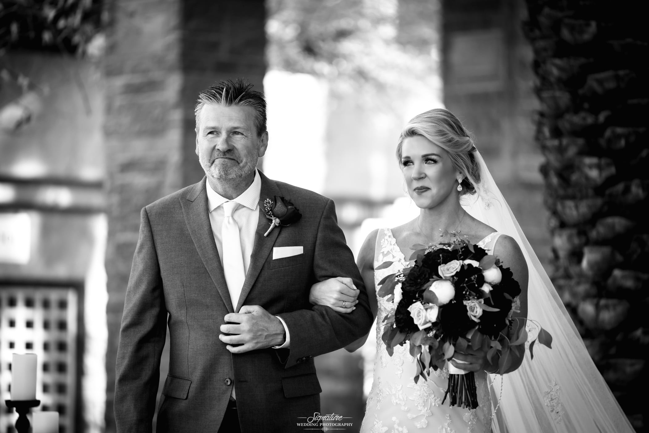 Father walking bride down isle black and white