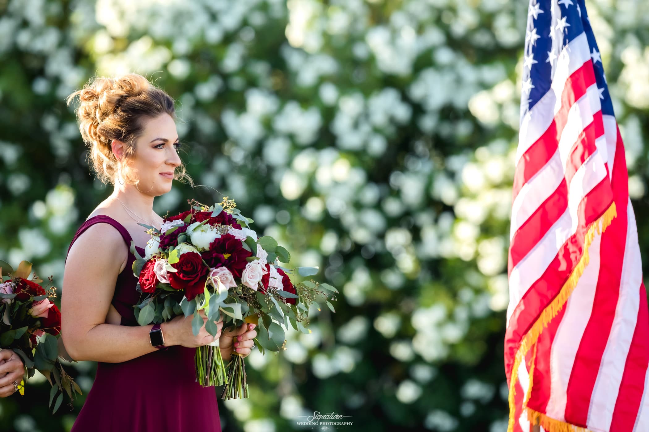 Maid of honor holding bouquet during ceremony