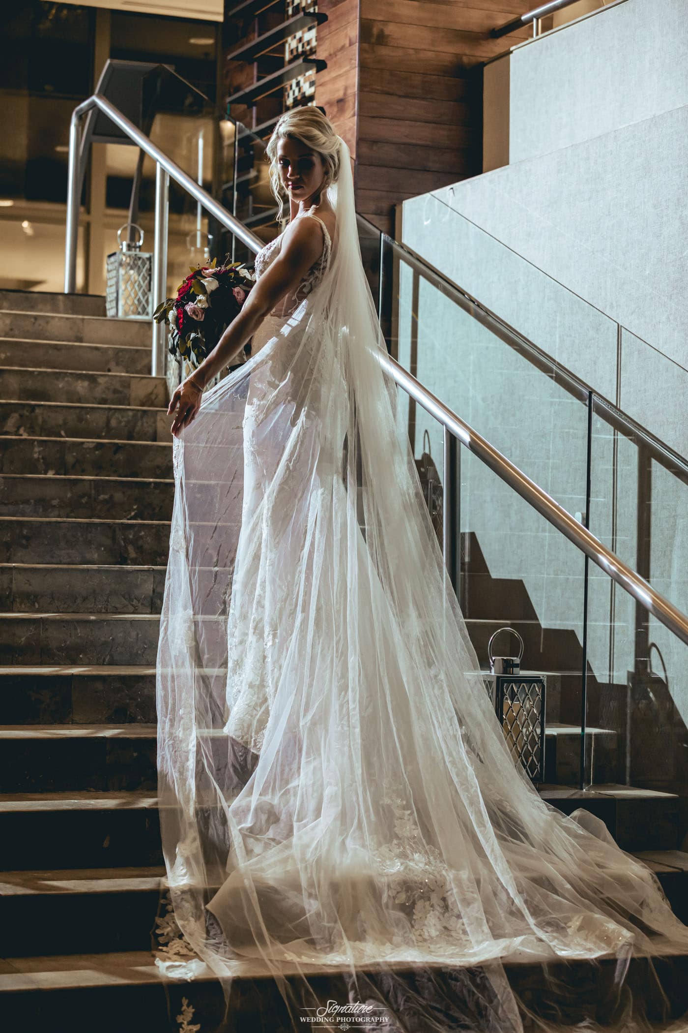 Back of bride's dress and veil on stairs
