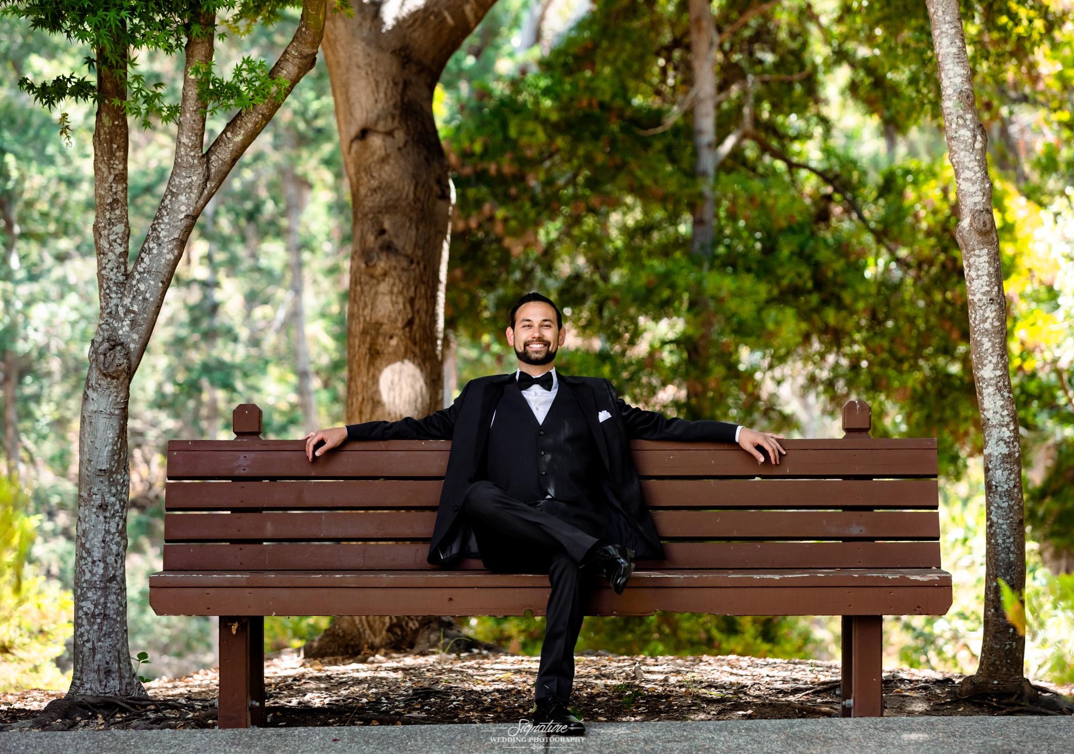 Groom sitting on bench outside