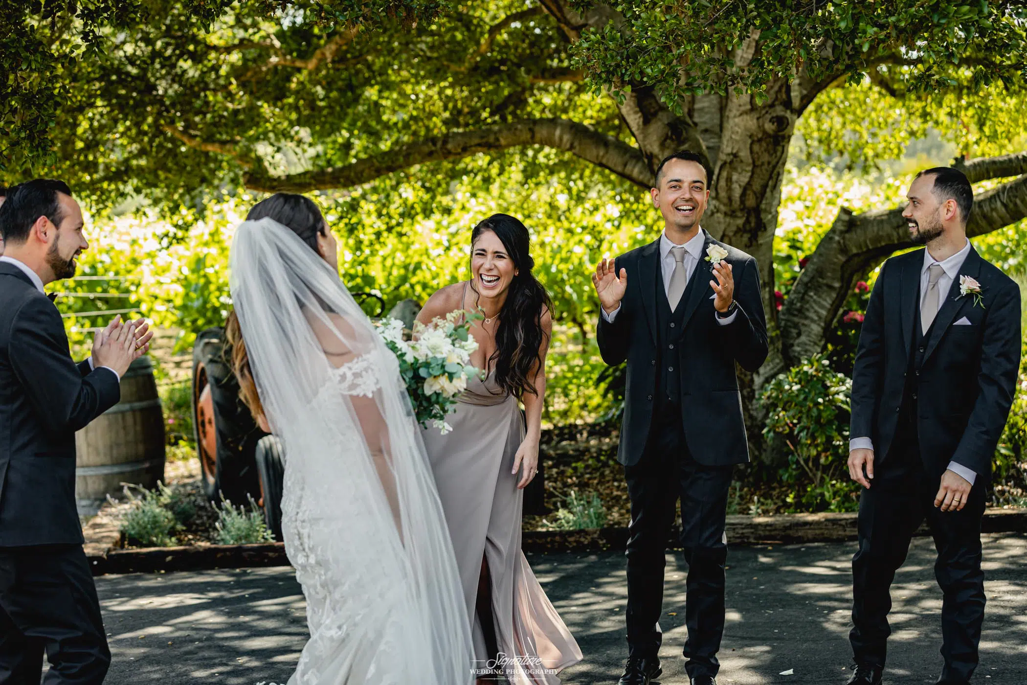 Bride and wedding party laughing candid
