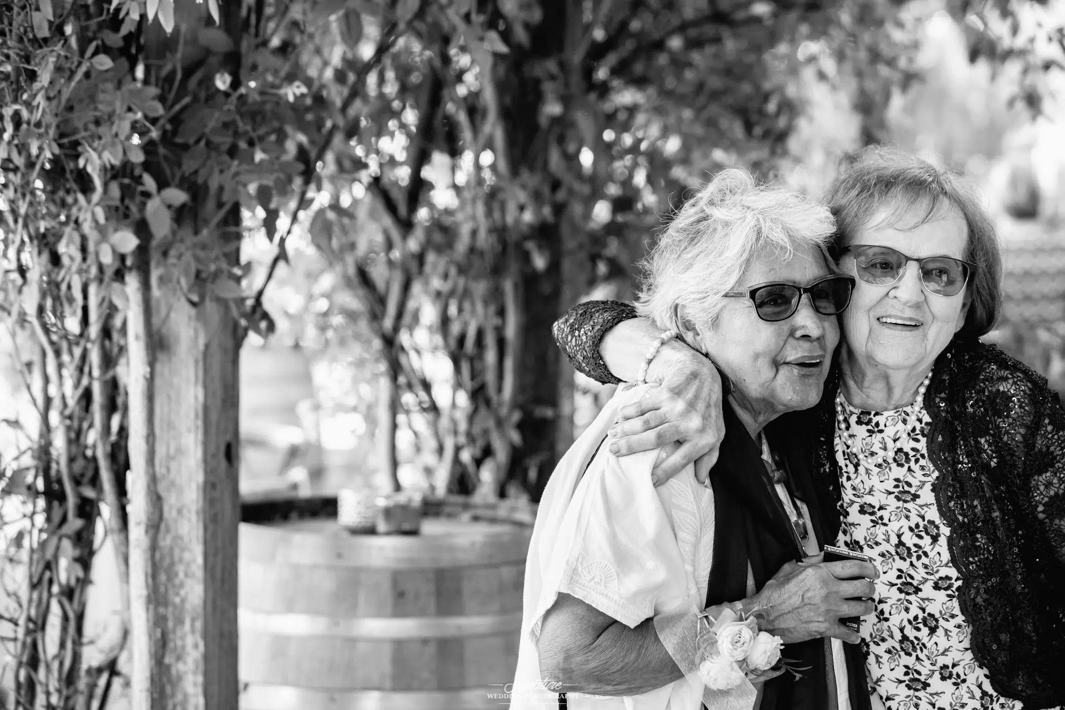 Two ladies hugging side by side