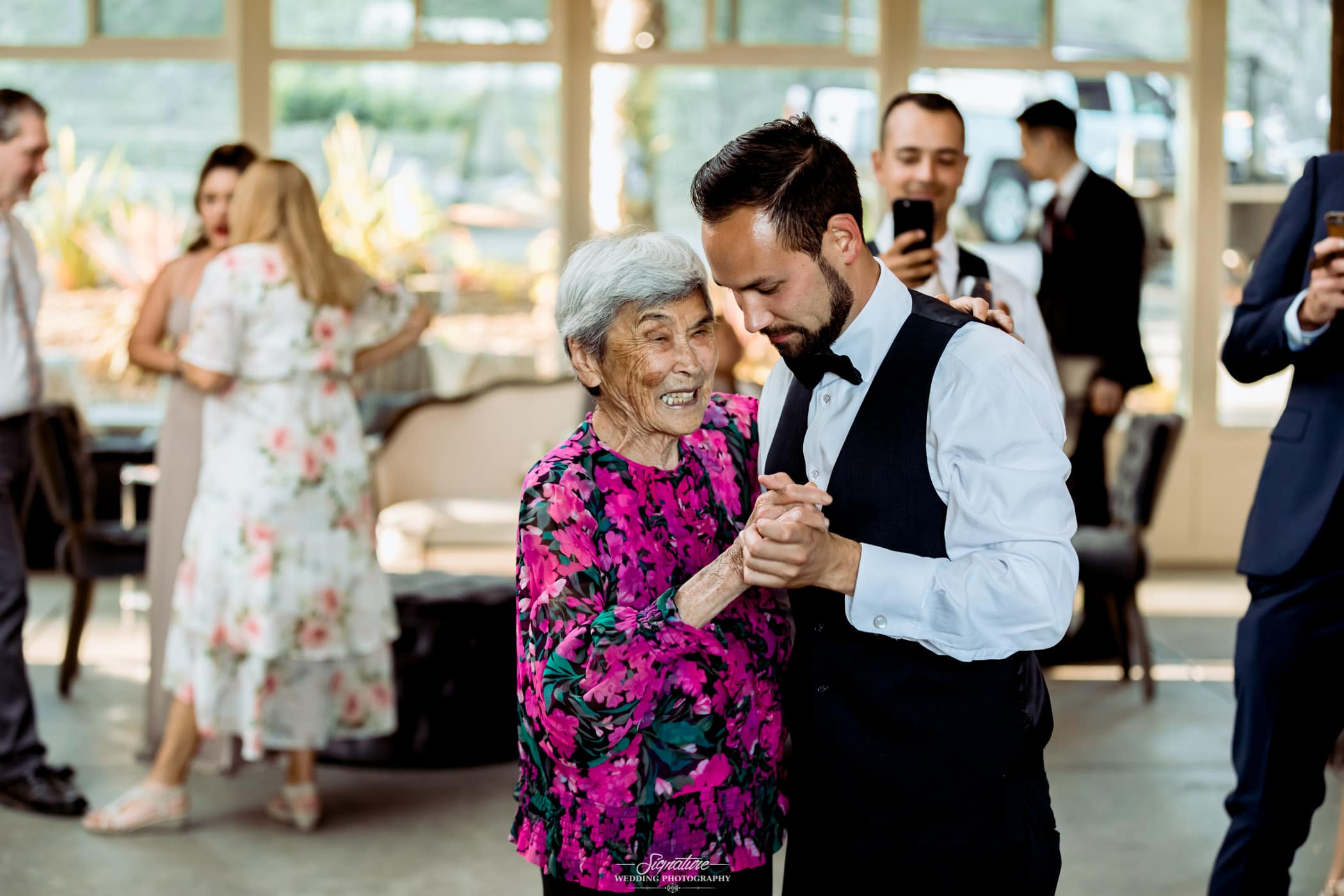 Groom dancing with matriarch