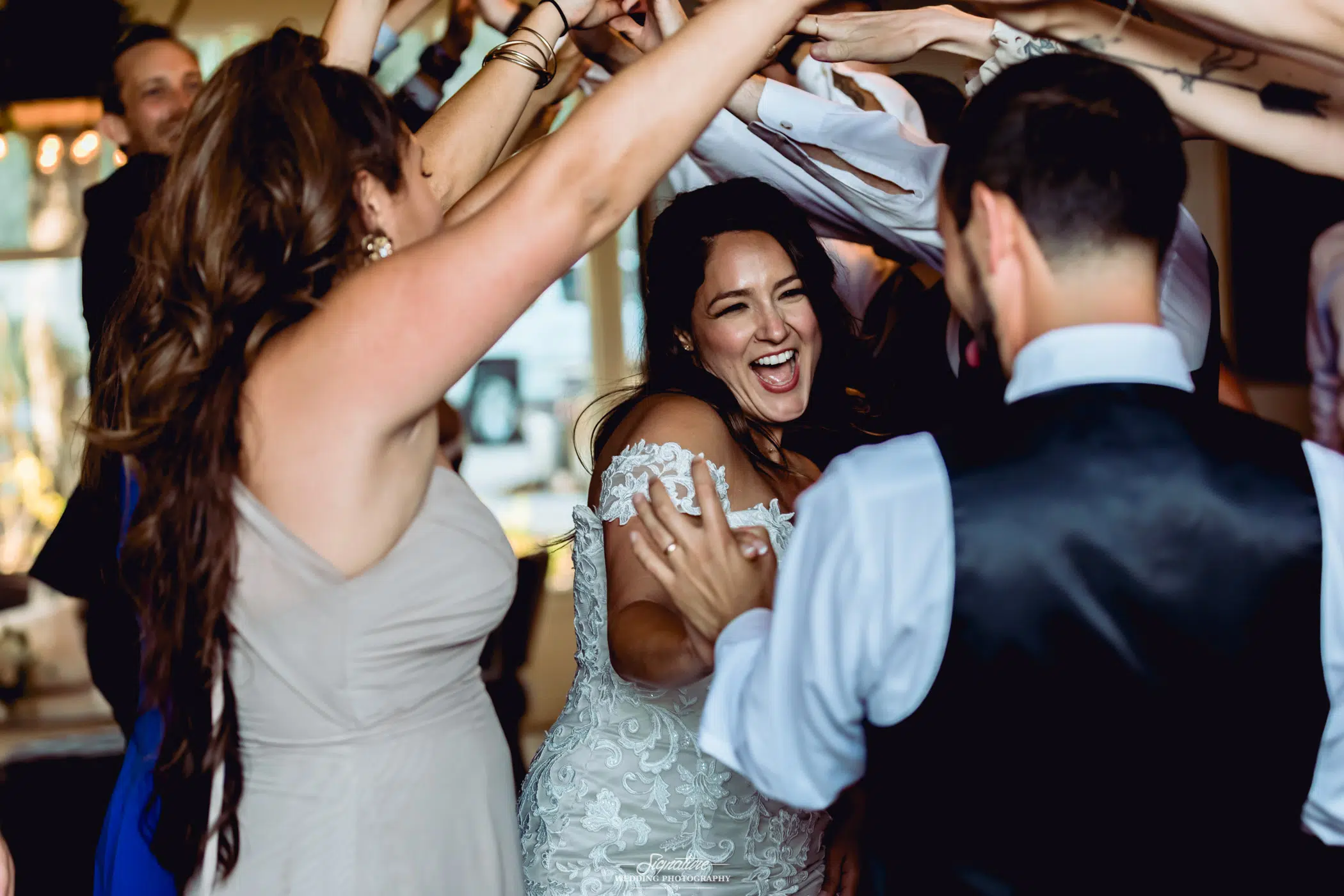 Bride and groom under tunnel of arms
