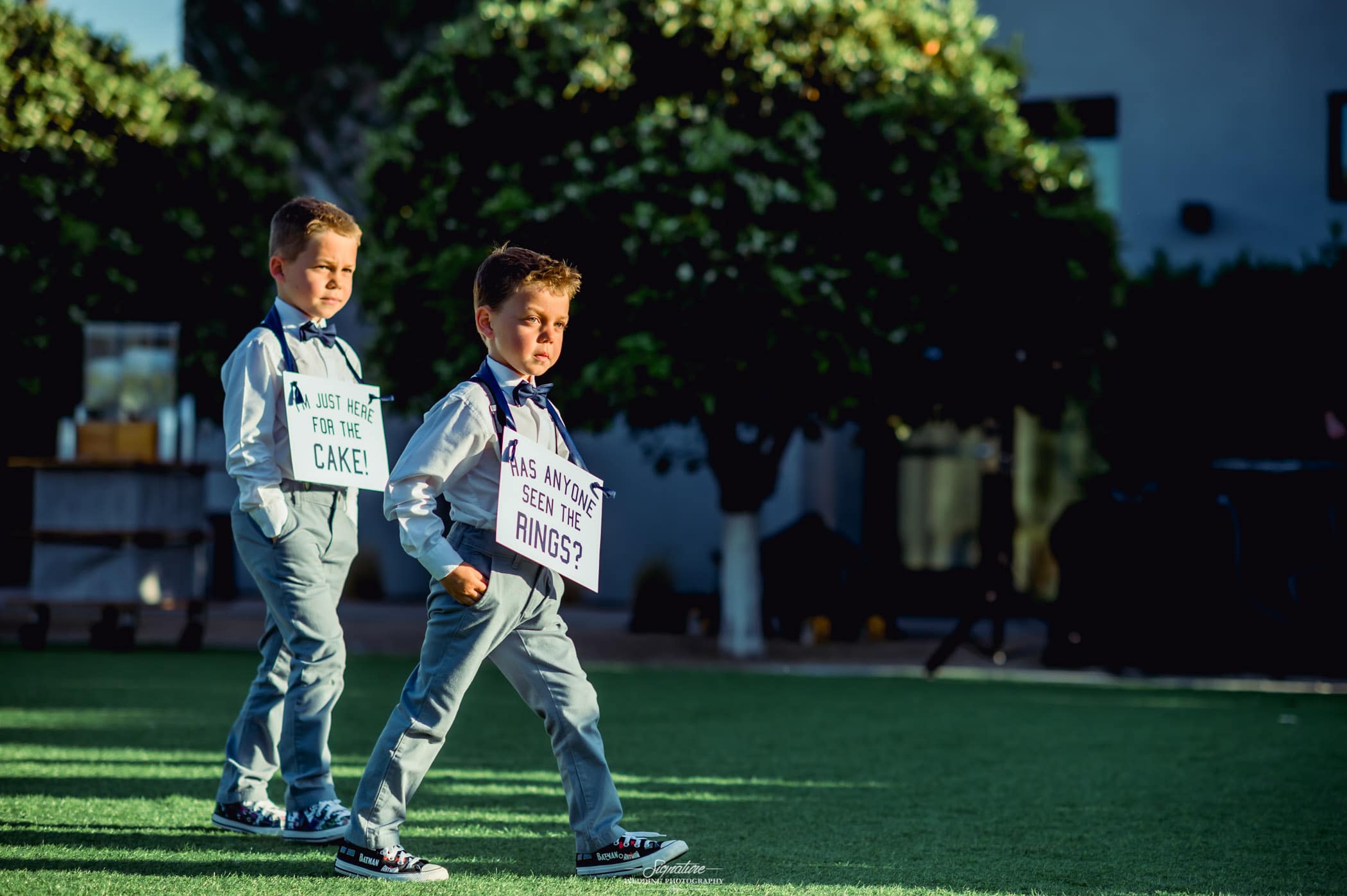 Ring bearers with signs around neck