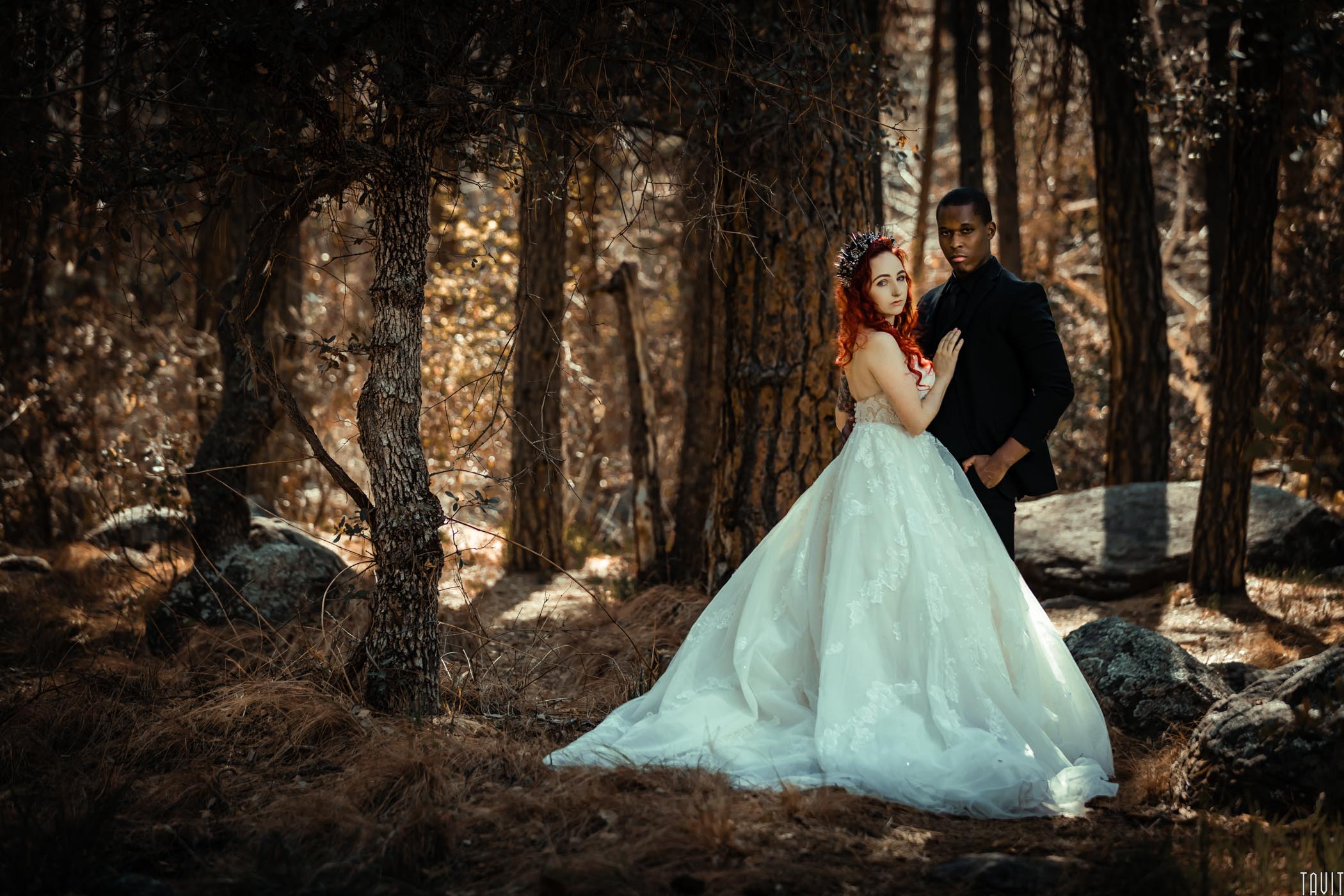 Bride with hand on grooms chest in forest