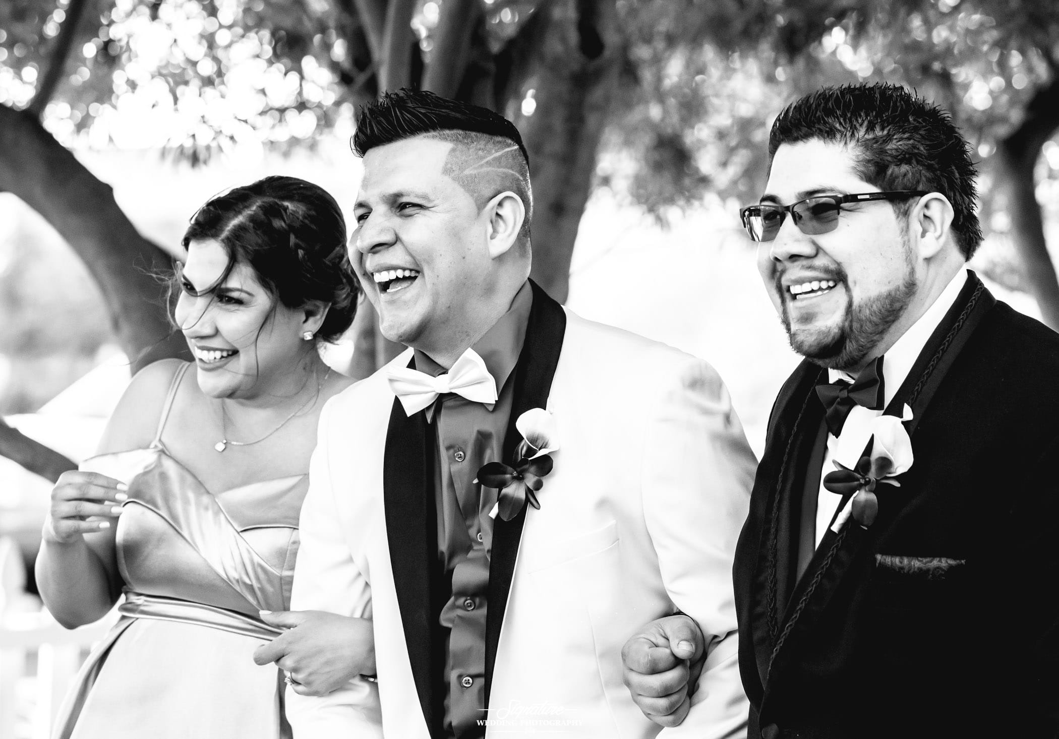Groom with wedding party members candid black and white