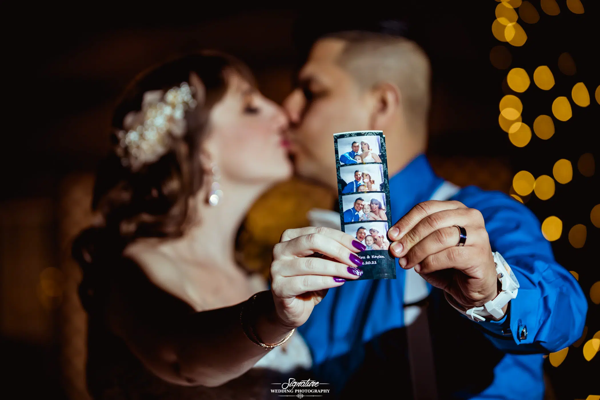 Bride and groom kissing holding photo booth picture strip