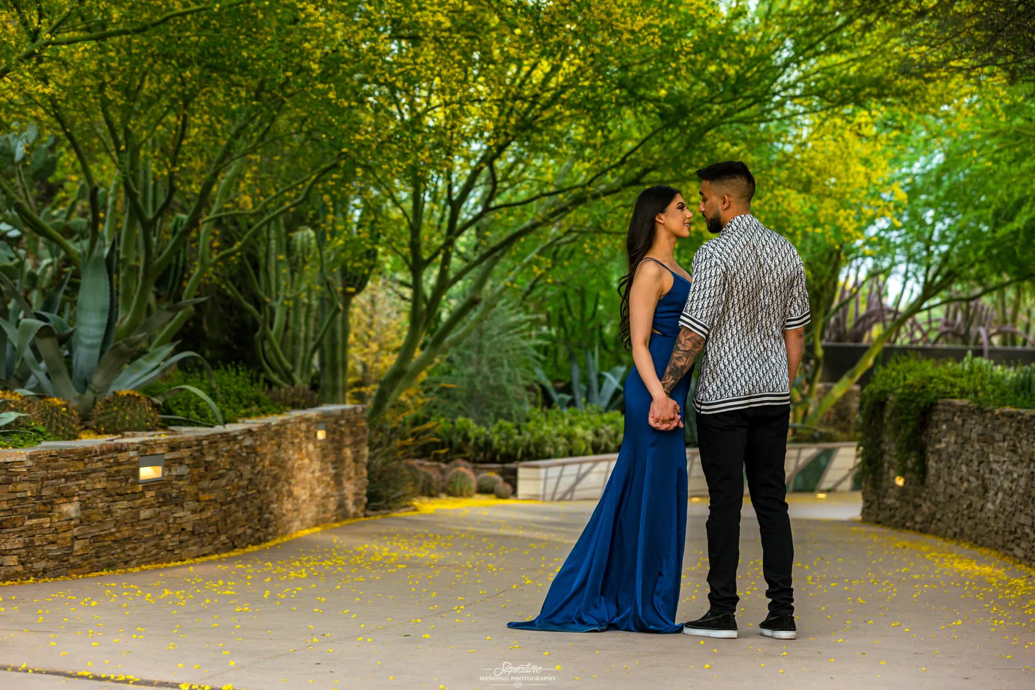 Couple looking at each other holding hands outside