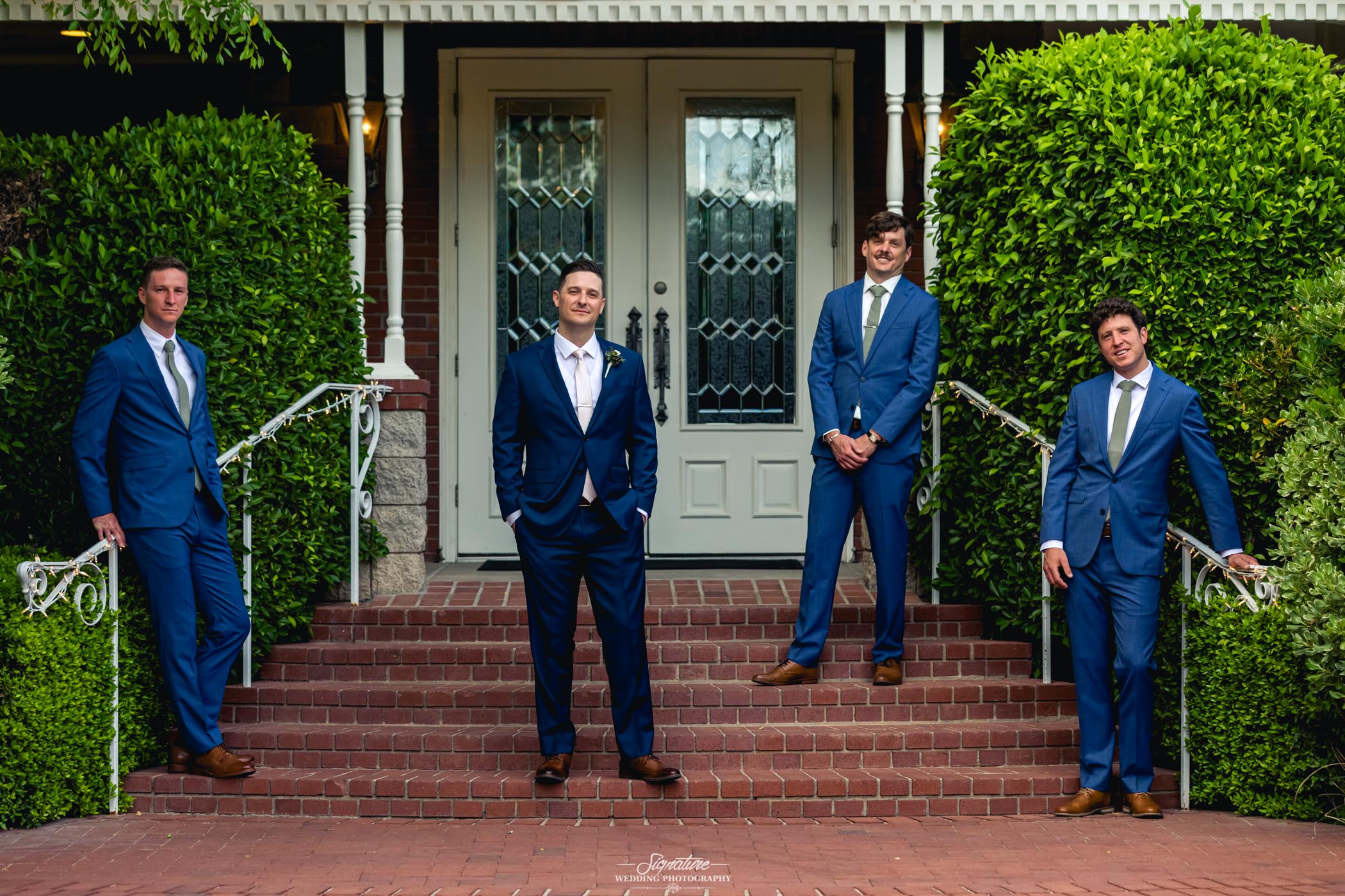 Groomsmen spaced out on stairs