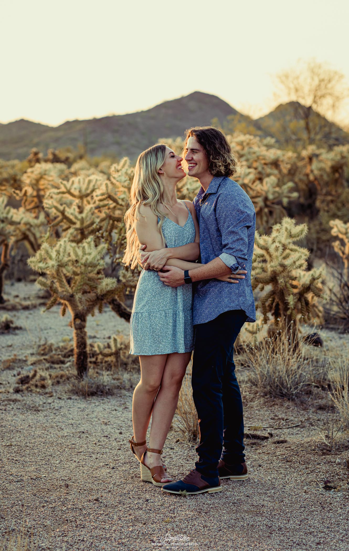 Couple smiling at each other in desert engagement shoot