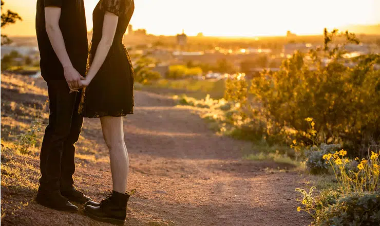 Couple holding hands on desert path