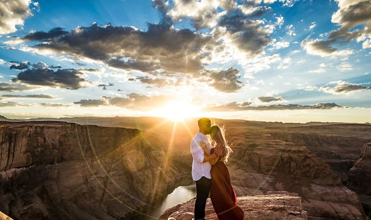 Couple hugging on mountain top at sunset