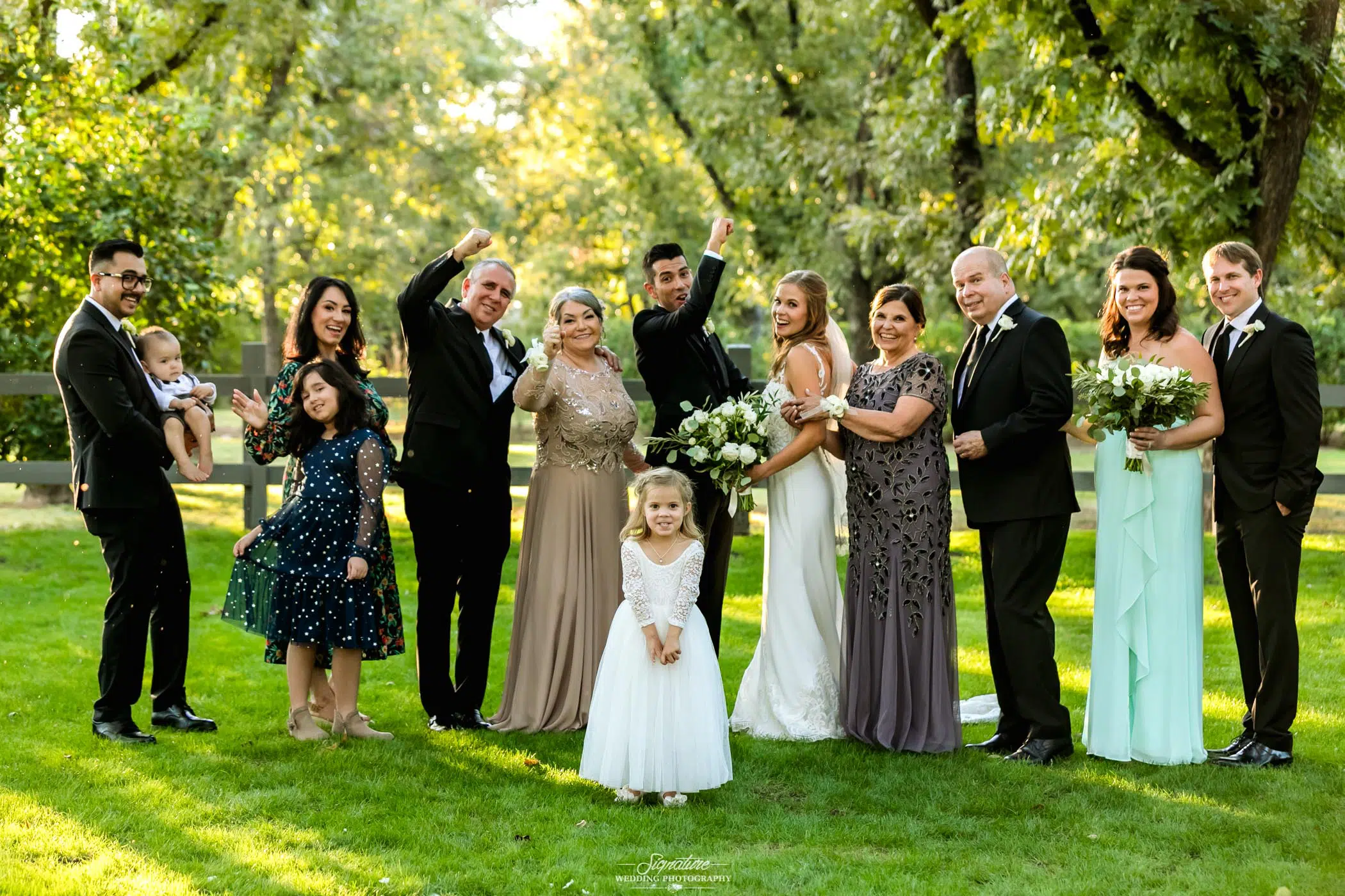 Bride and groom family picture outside