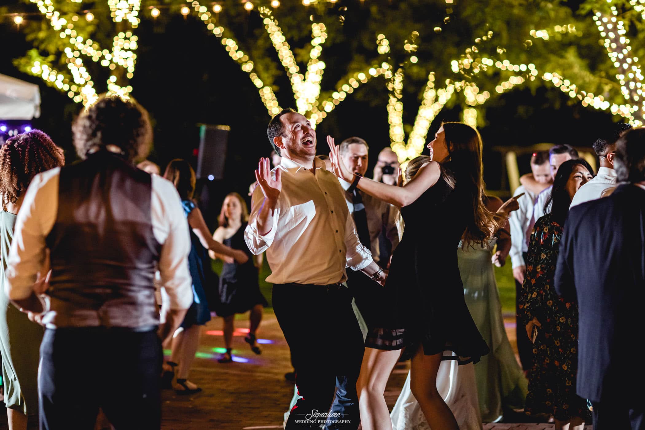 Wedding guests dancing outside candid