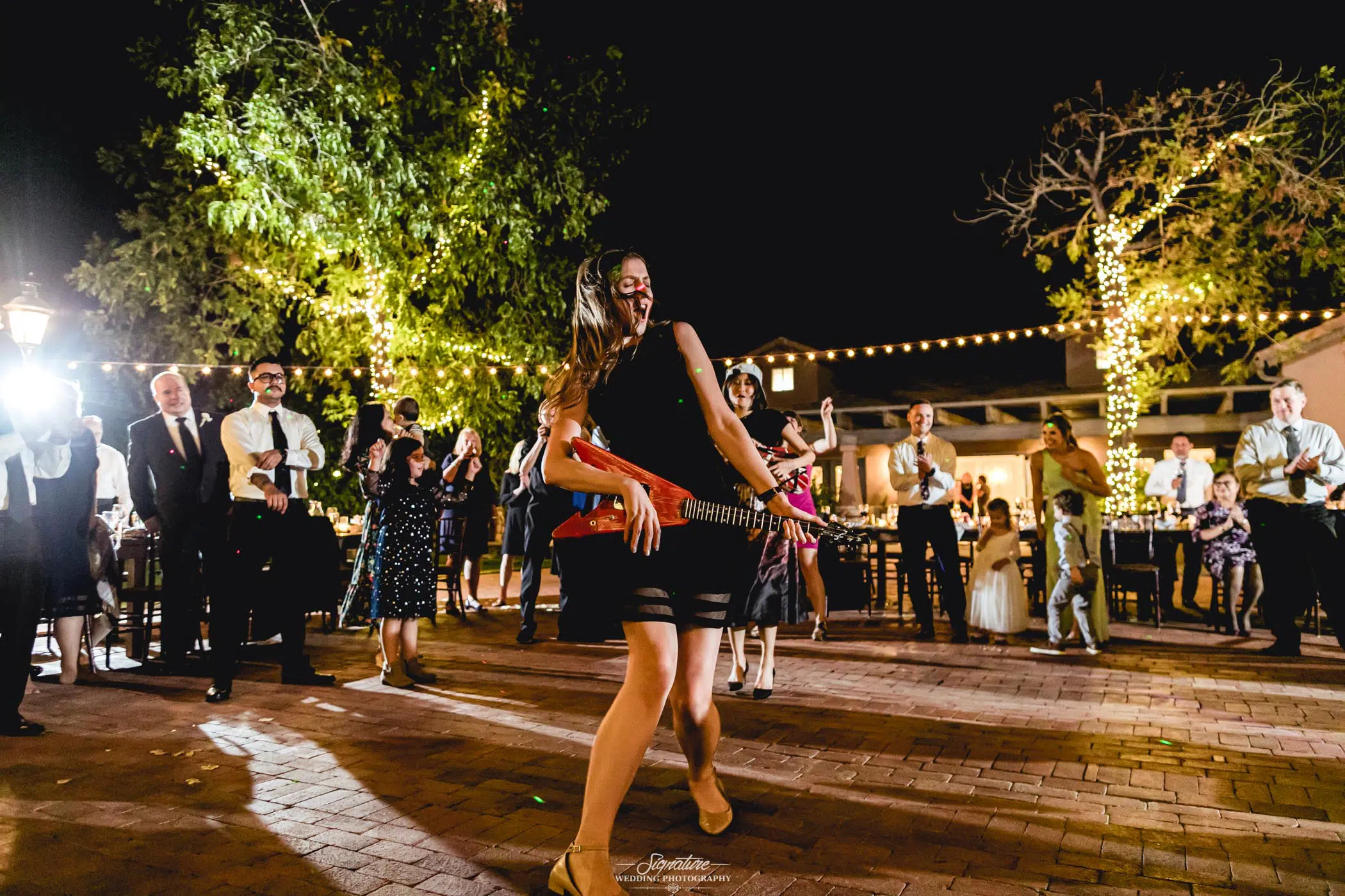 Wedding guests on dance floor with guitar