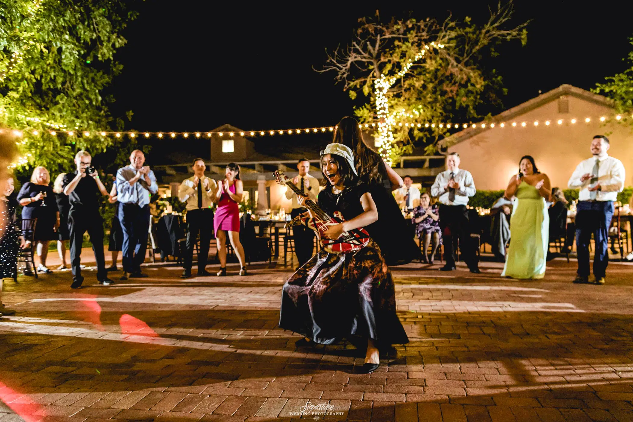 Wedding guests on dance floor with guitar