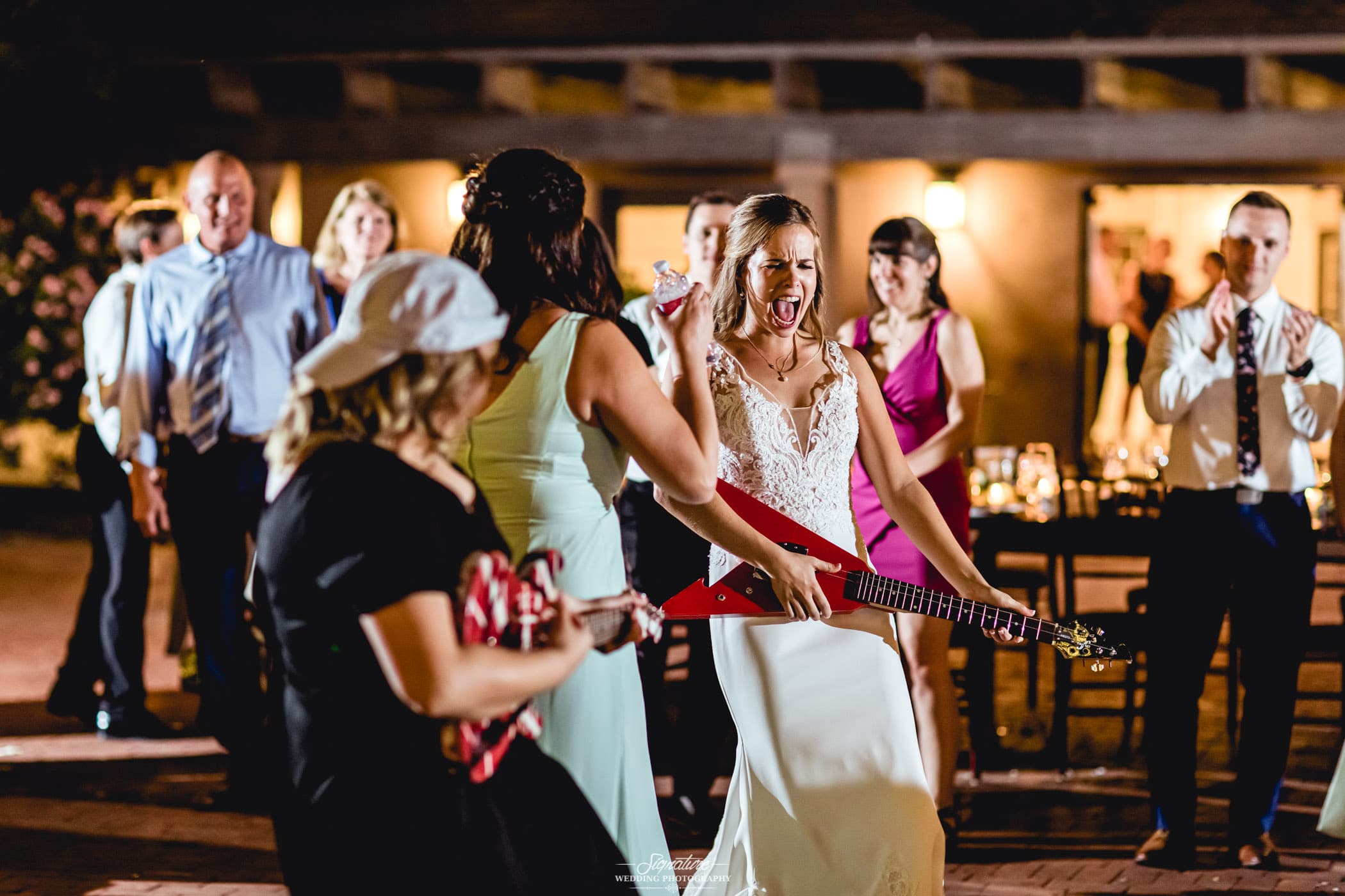 Bride and wedding guests with guitars