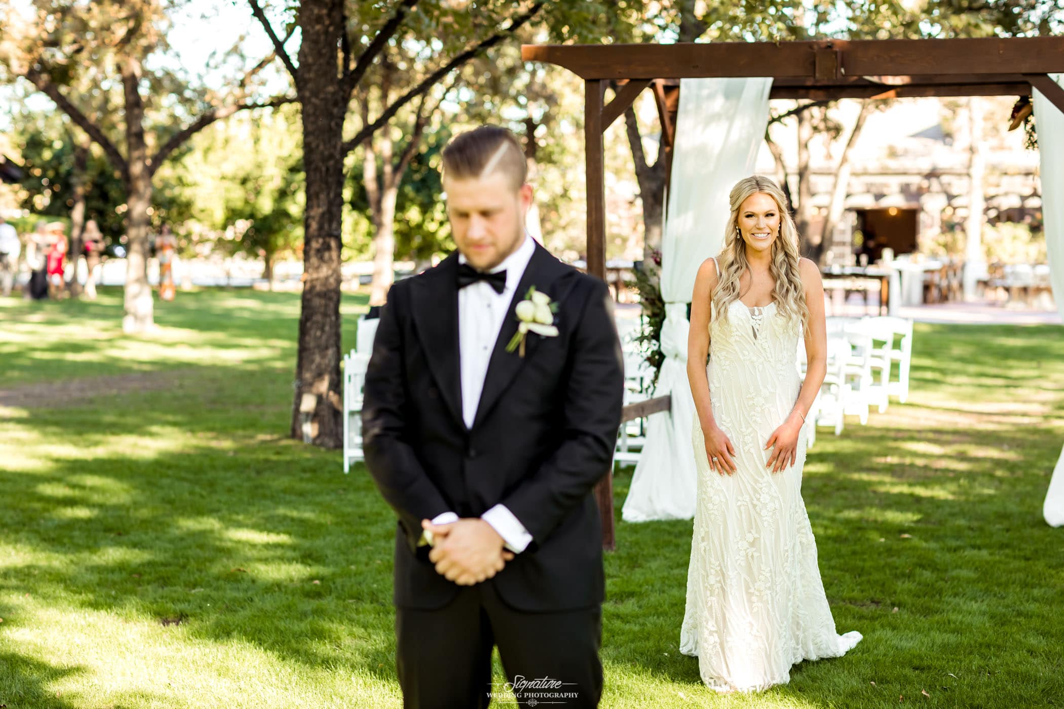 Bride standing behind groom for first look