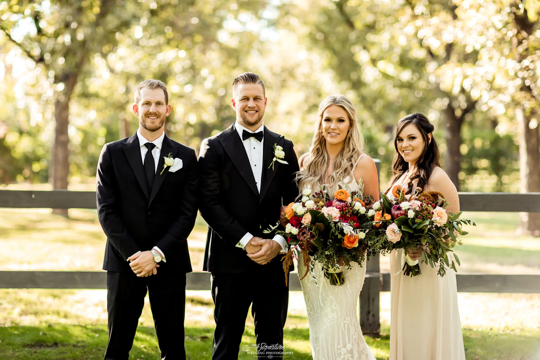 Groom with best man and bride with maid of honor smiling