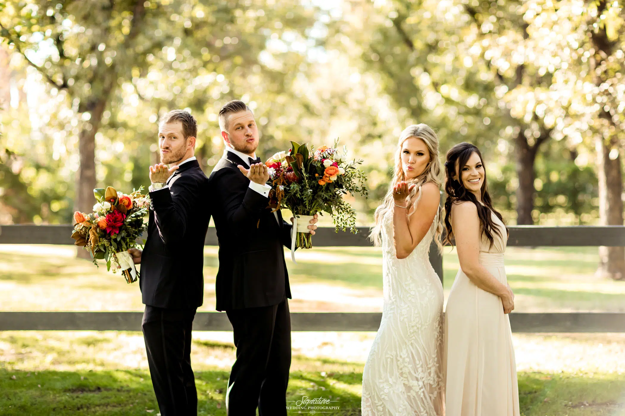 Groom with best man and bride with maid of honor blowing kiss