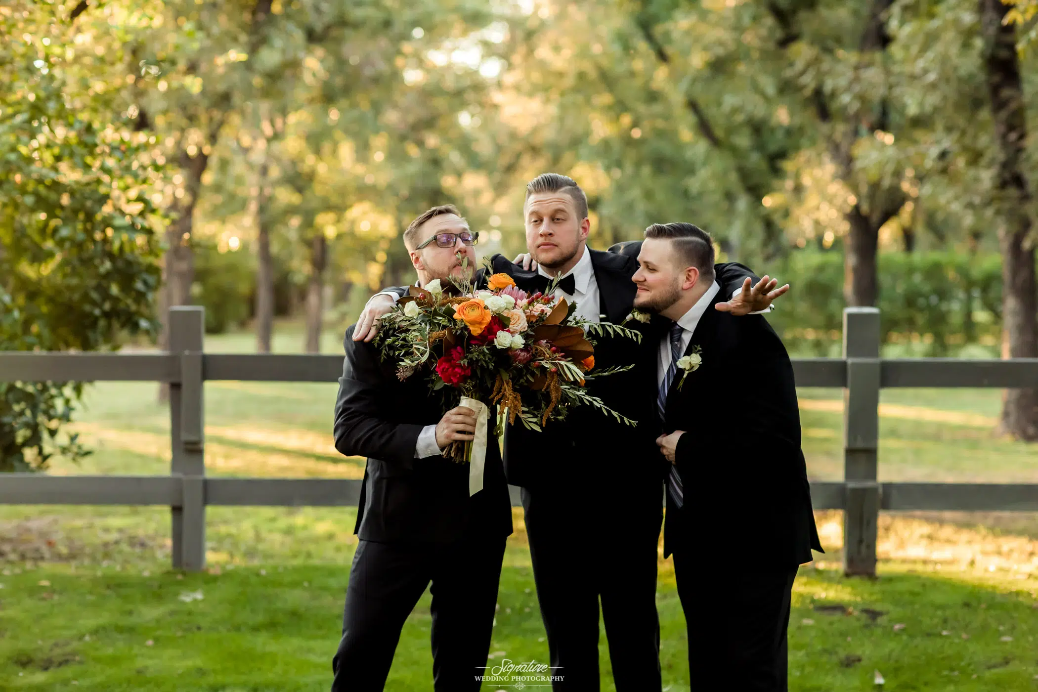 Groom and groomsmen smelling bouquet