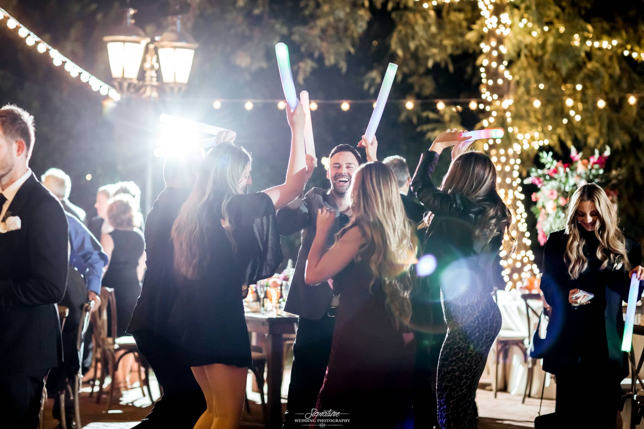 Wedding guests dancing with light up sticks