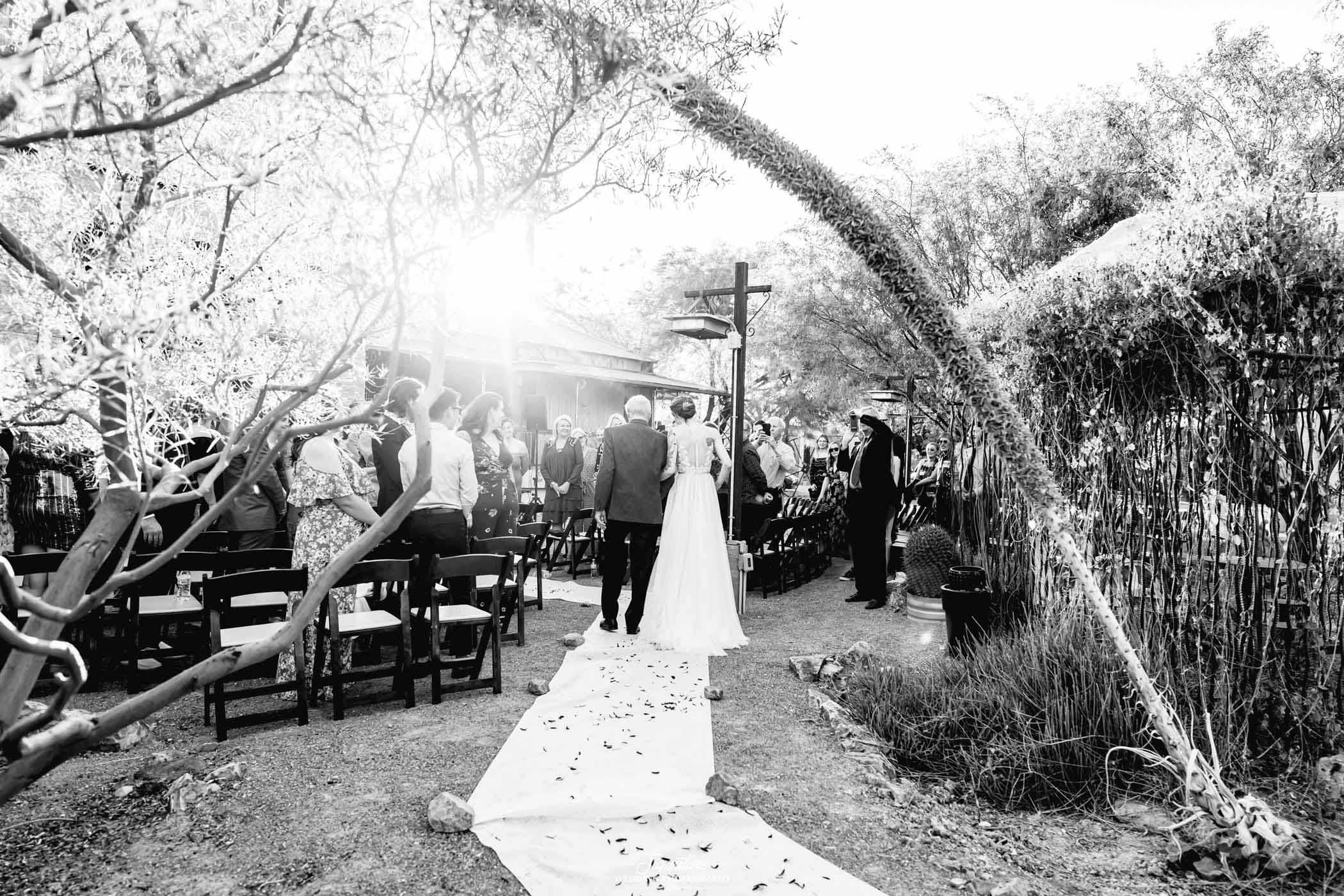 Father walking bride down aisle black and white