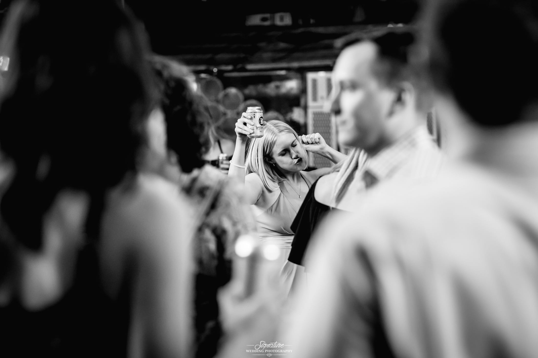Wedding guest dancing candid black and white