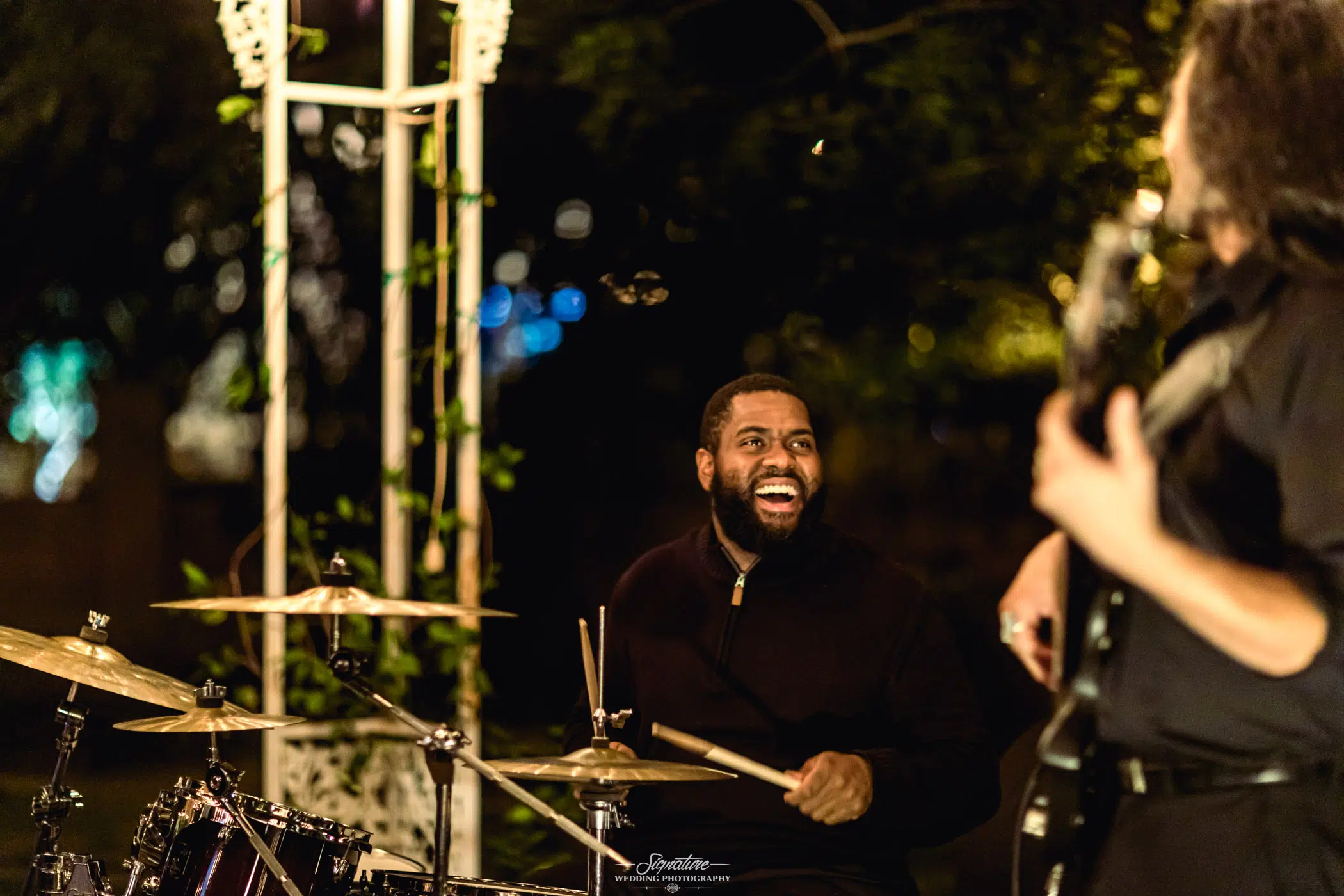 Drummer smiling at guitarist