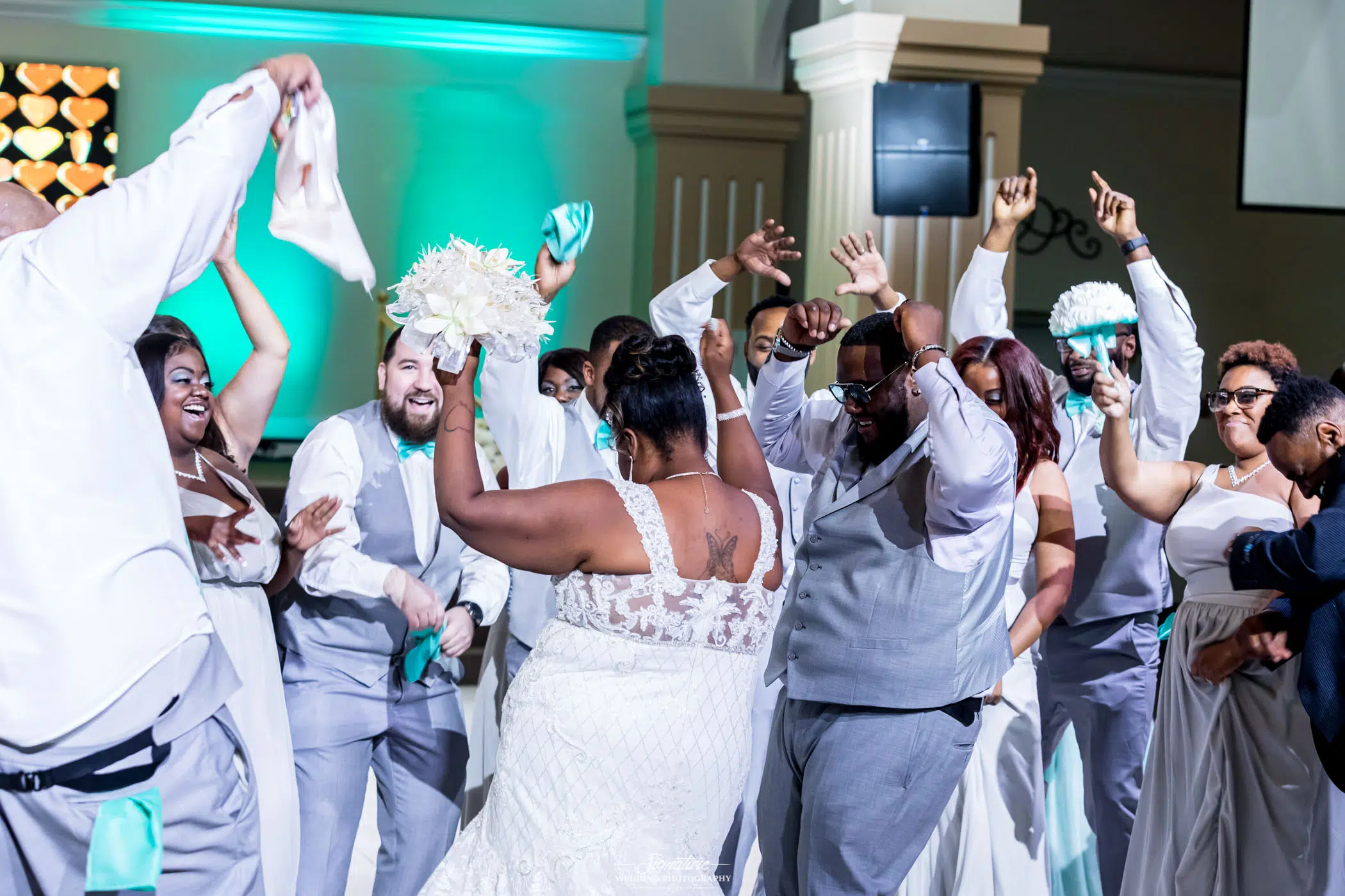Bride and groom dancing with wedding party