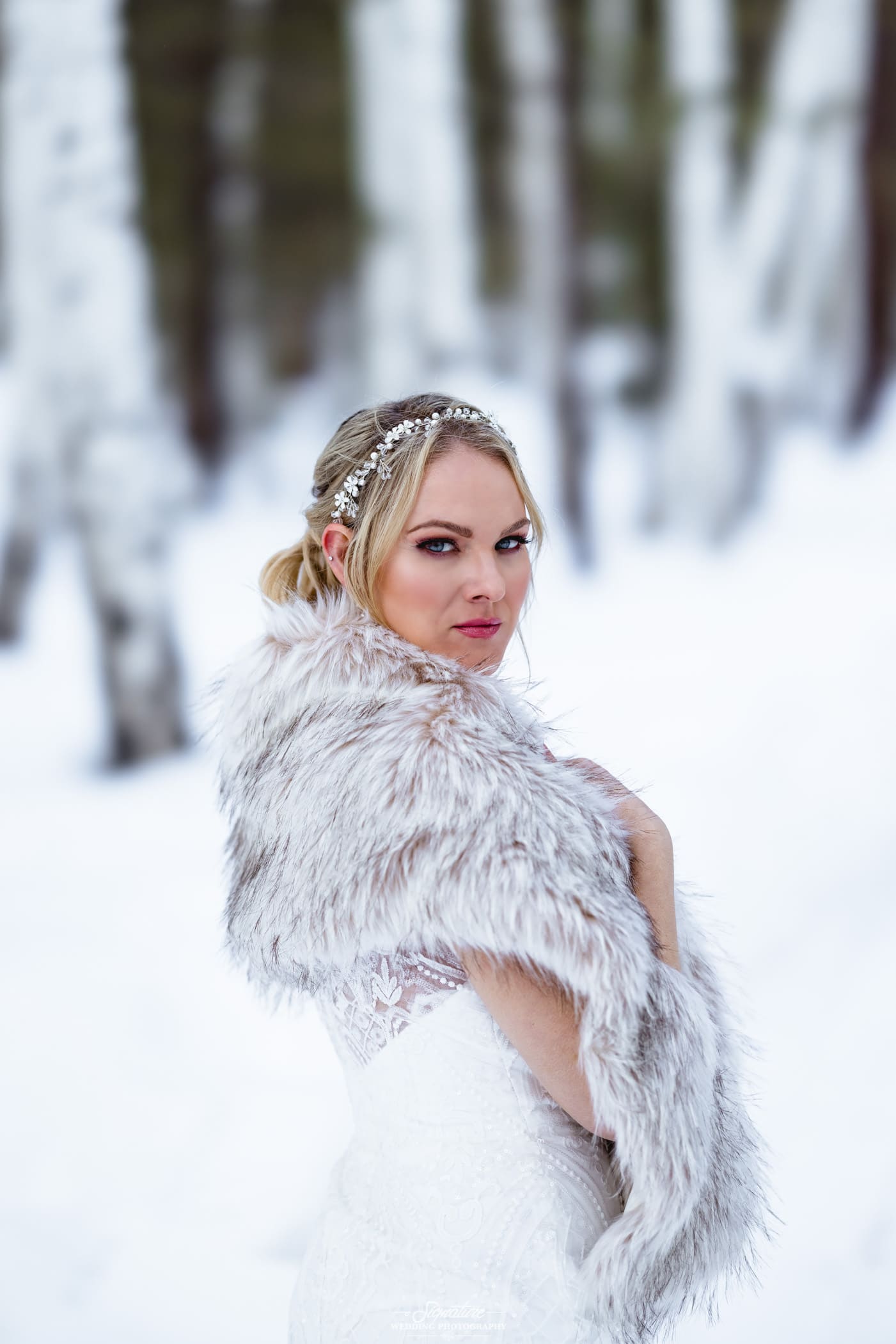 Bride looking over shoulder in snow