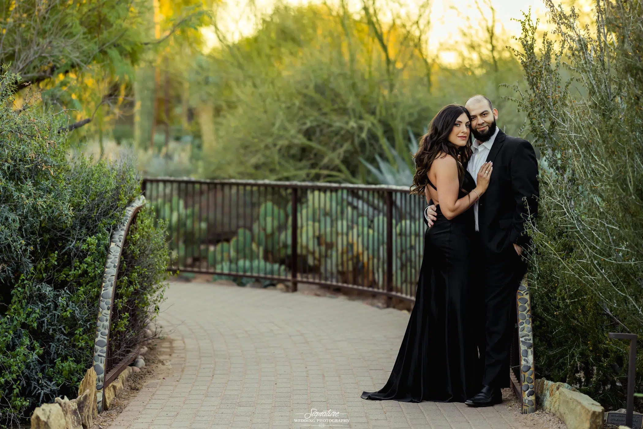 Couple hugging with desert greenery