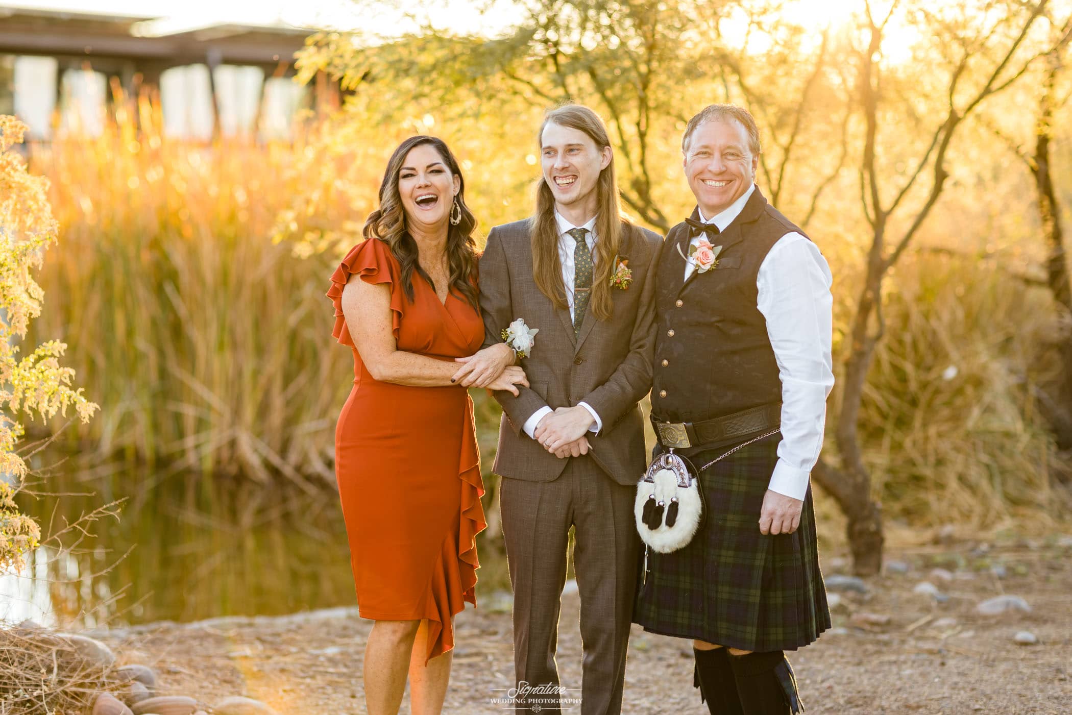 Groom with parents smiling