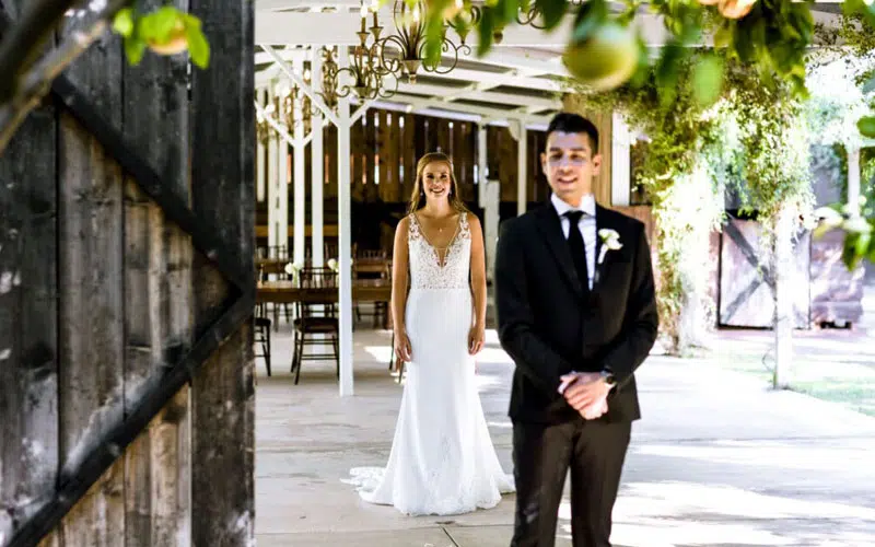 Bride standing behind groom for first look