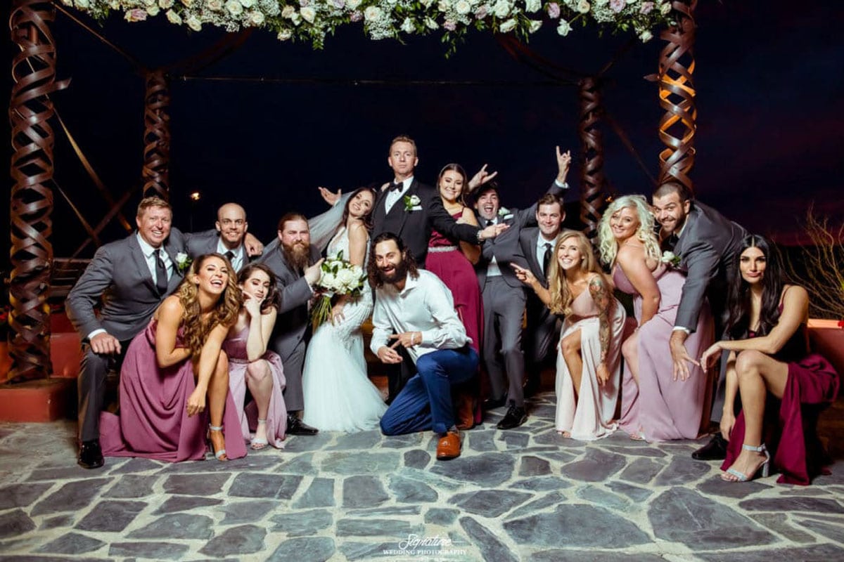 Bride and groom with wedding party in fun pose