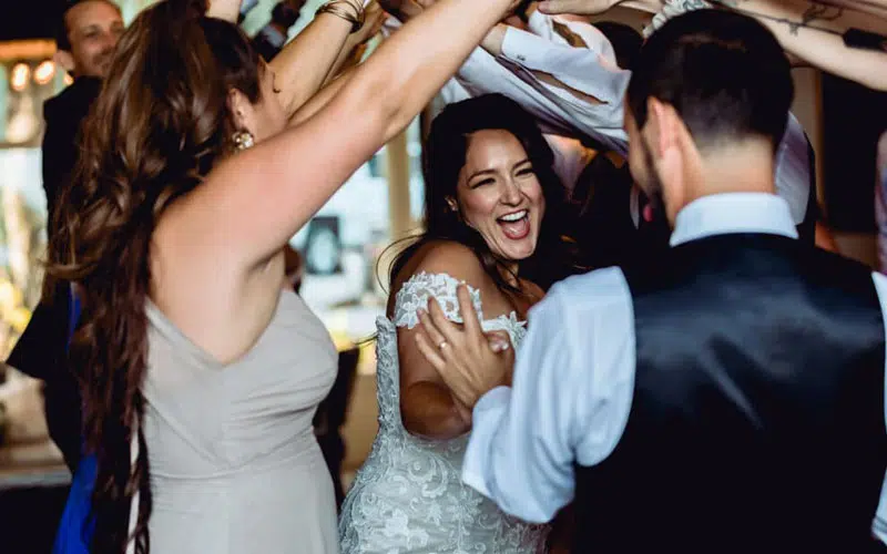 Bride and groom under tunnel of arms