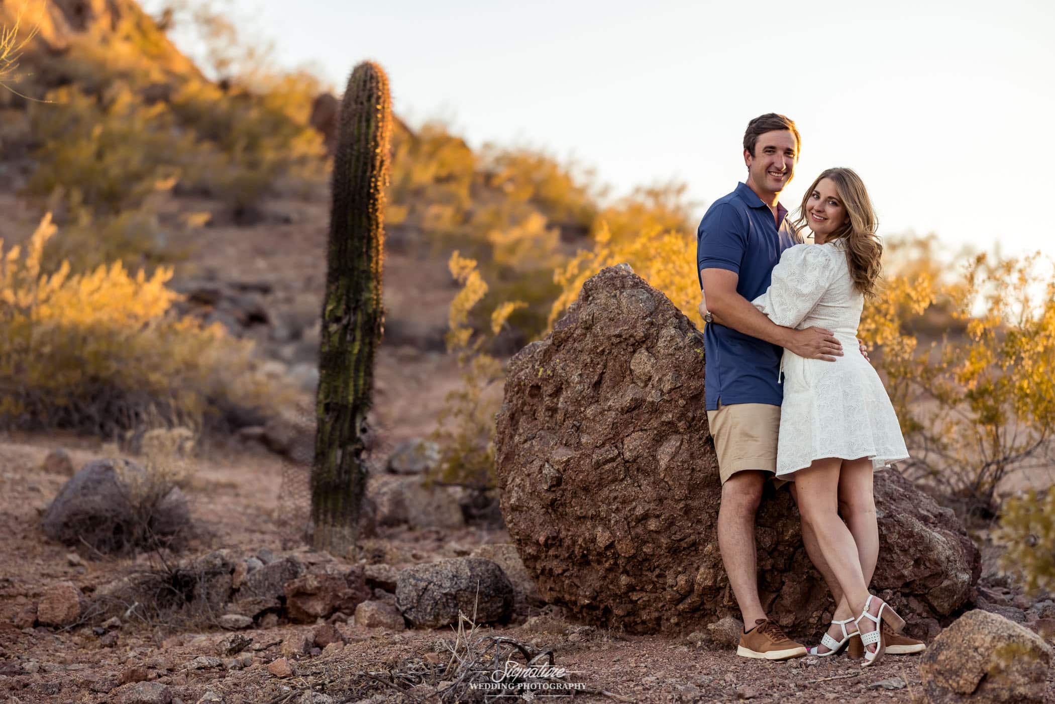 Couple hugging next to cactus