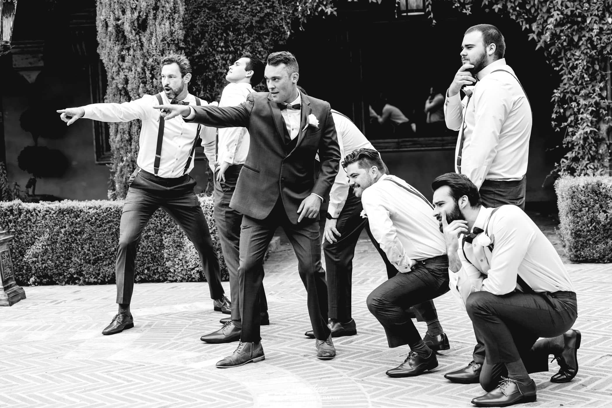 Groom and groomsmen funny pose black and white
